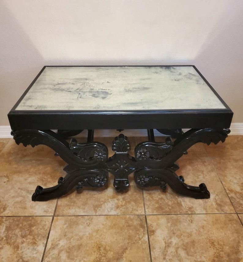 A phenomenal rare Parisian Empire period hand carved later ebony lacquered low table / coffee table converted from a piano stool of the same period, having later added smoky glass mirrored top, over simple unadorned apron, above a base embellished