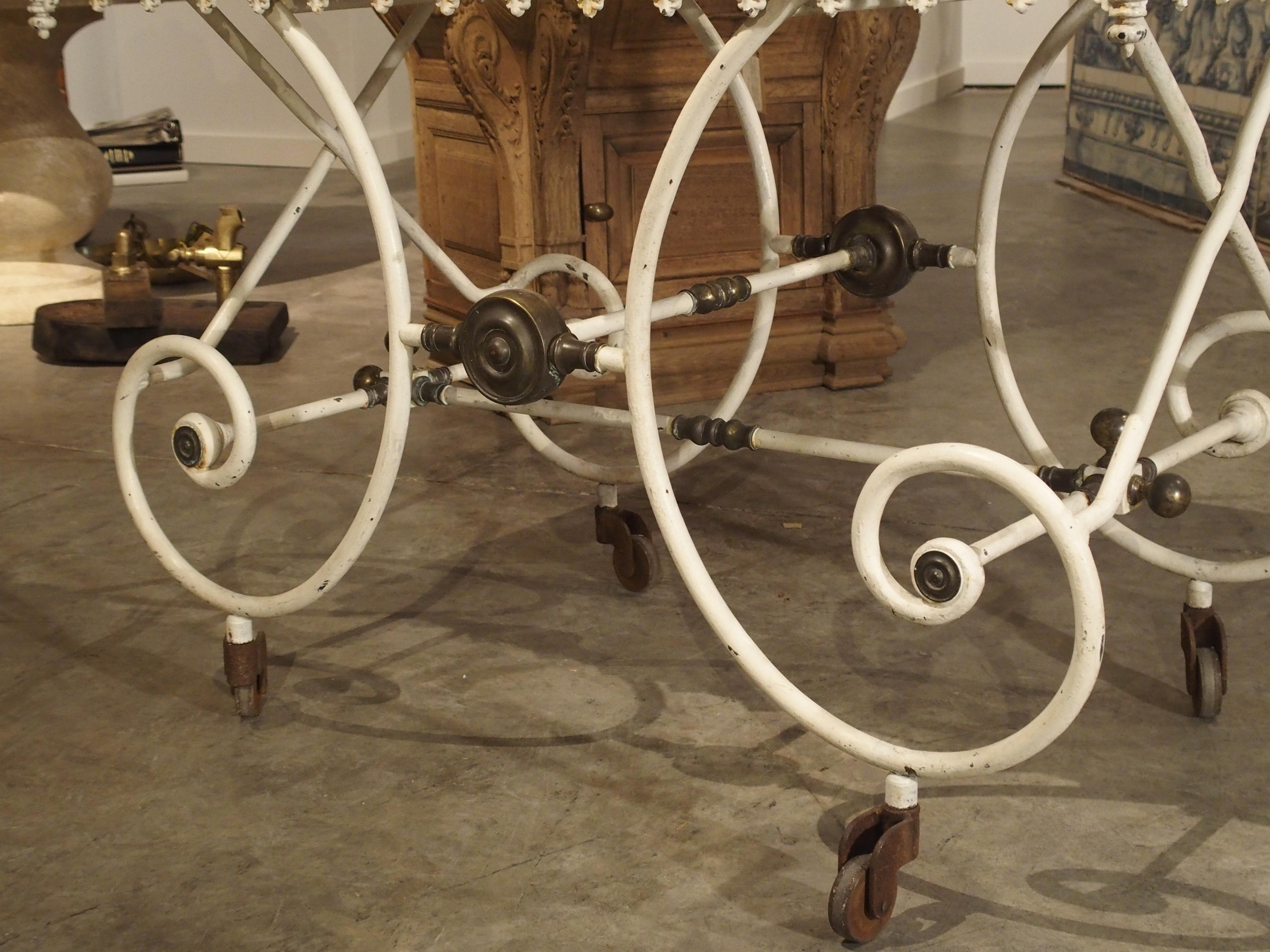 From France, this rectangular white painted iron, bronze and white Carrara marble table dates to the 1800s. These wonderful tables were originally used to roll or shape dough for the making of pastries. They were also used as display tables in