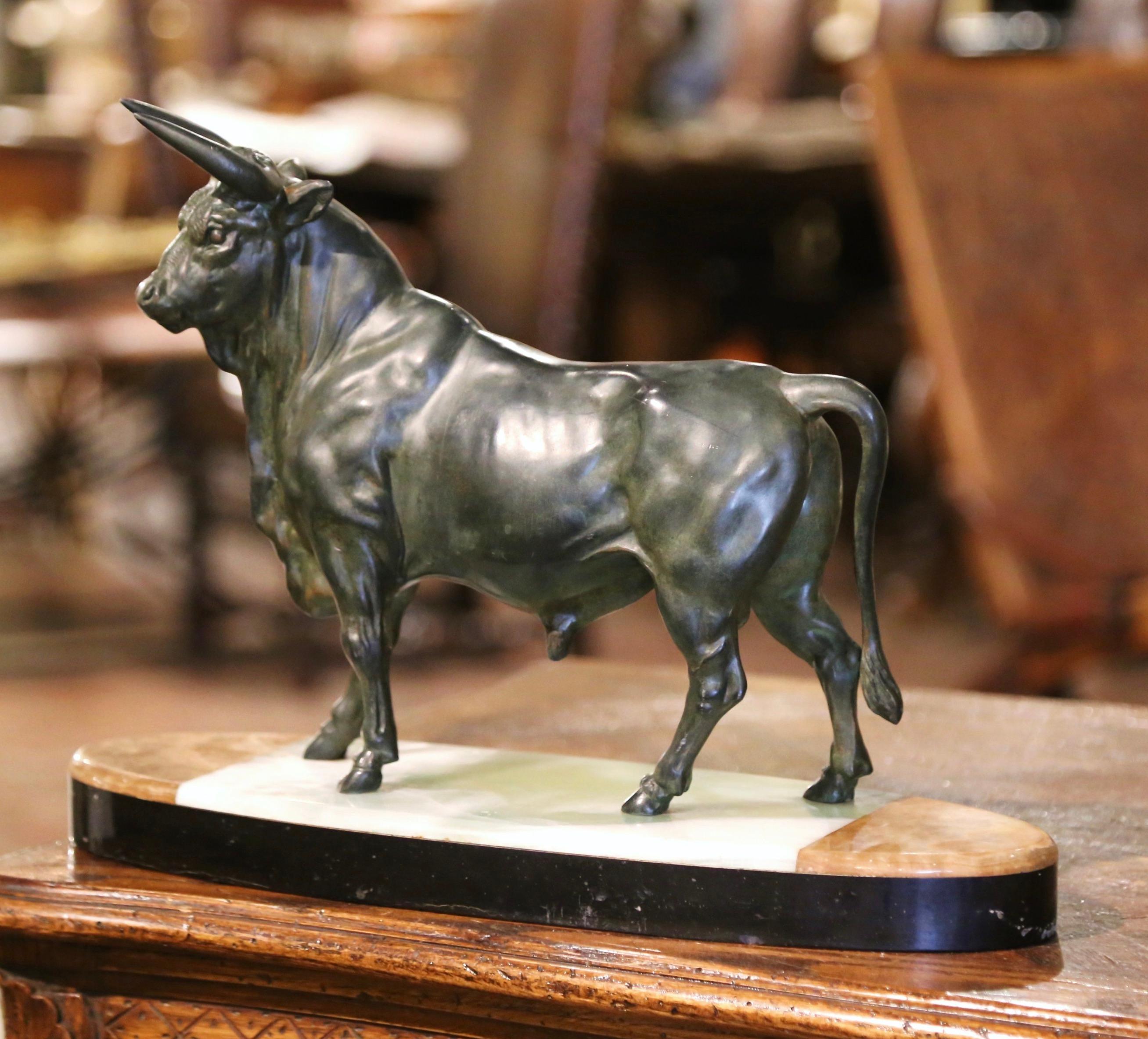 Decorate a man's desk or a library shelf with this antique bull sculpture. Created in France, circa 1890, the figure sits on an integral oval variegated onyx base and depicts a proud bovine in a standing position ready to charge. The sculpture is in