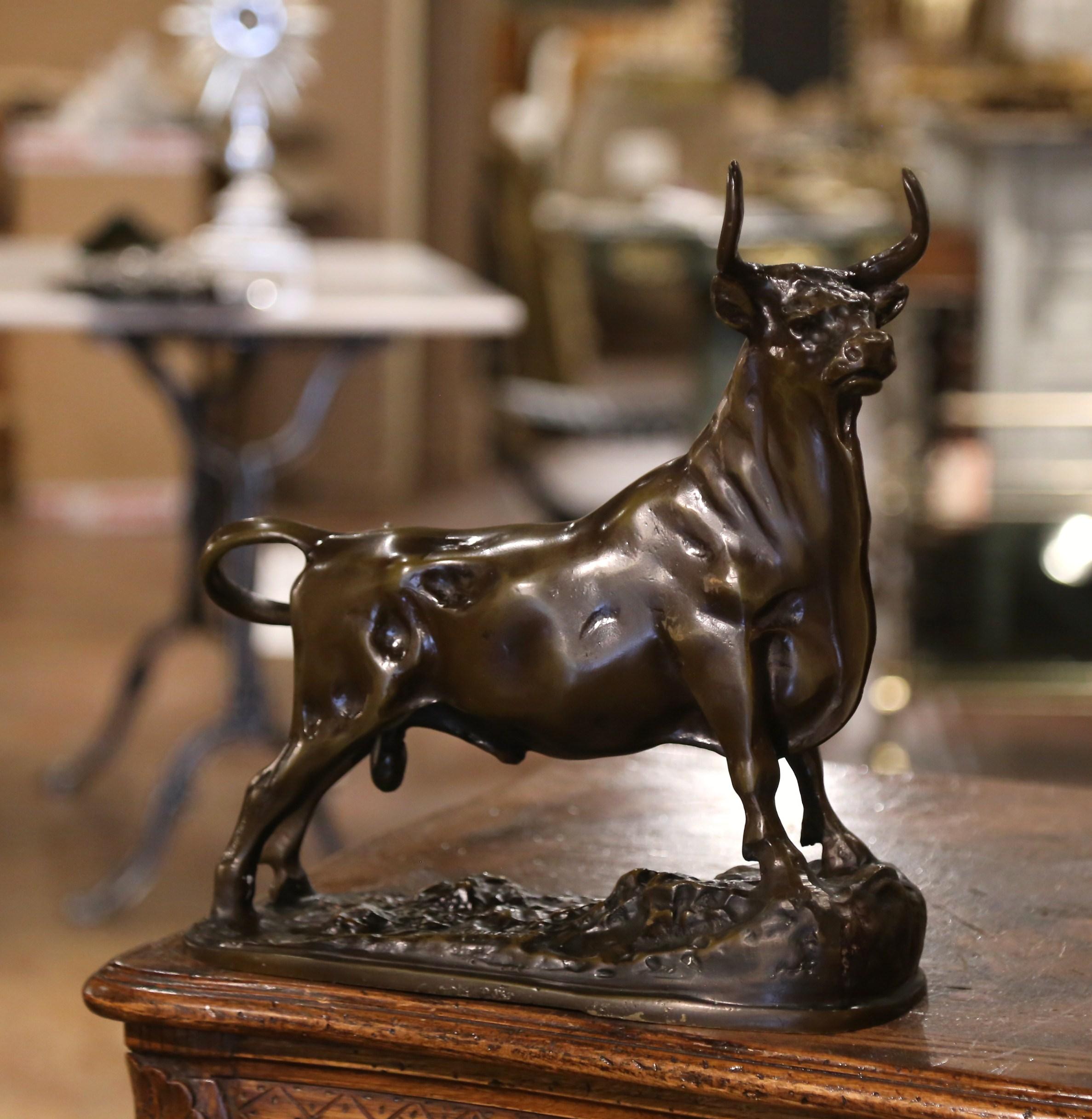 Place this large bronze bull sculpture in an office or a desk. Crafted in France, circa 1860 and beautifully executed, the patinated bovine figure is shown standing up on a textured base, looking defiant and proud. Signed on the side by the artist,