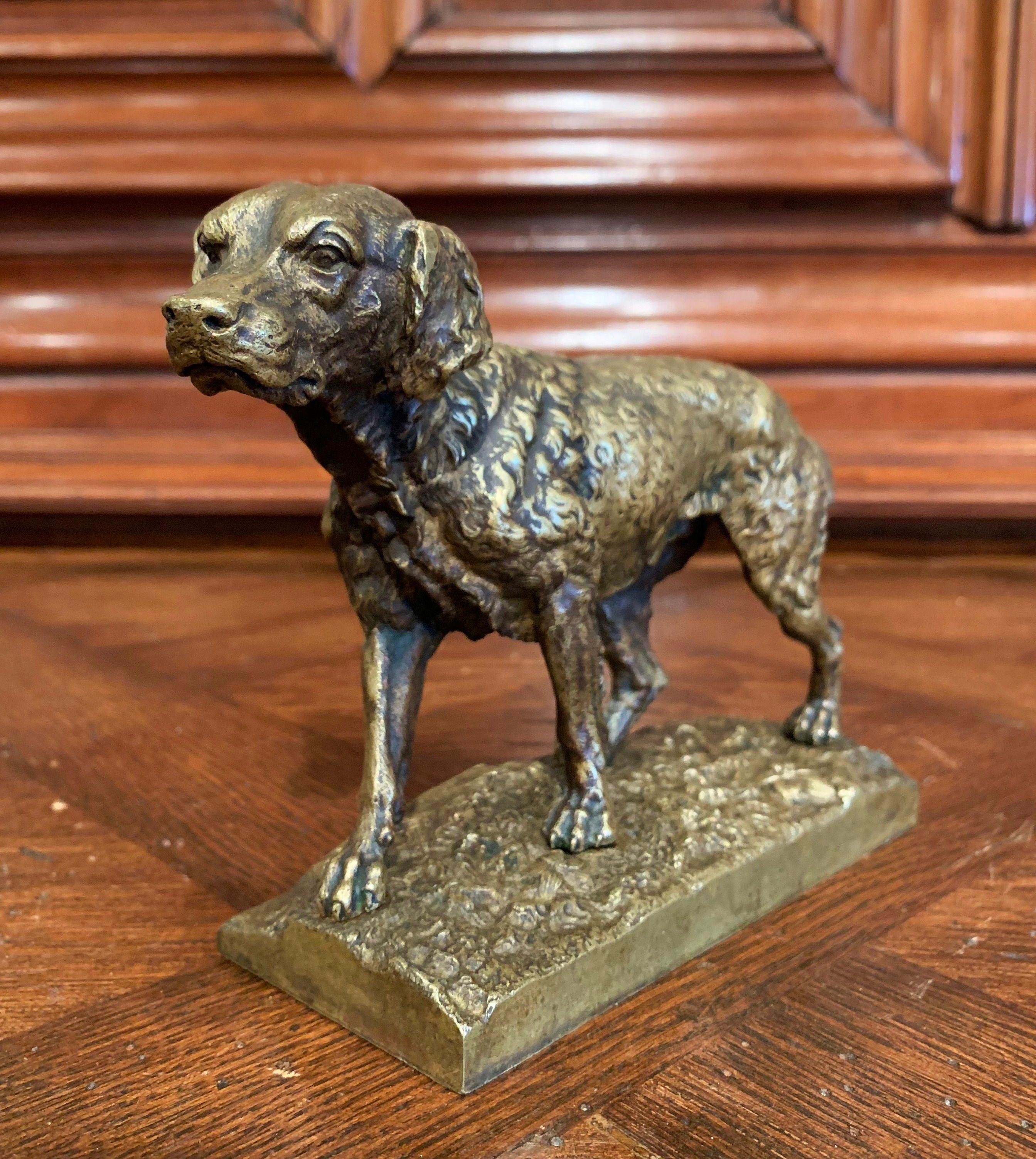 This antique bronze sculpture was created in France, circa 1870, in the manner of French sculptor Jules Moiniez. The composition features a setter standing on rocky ground with leaf and branch decor and looking ahead. The elegant piece is in