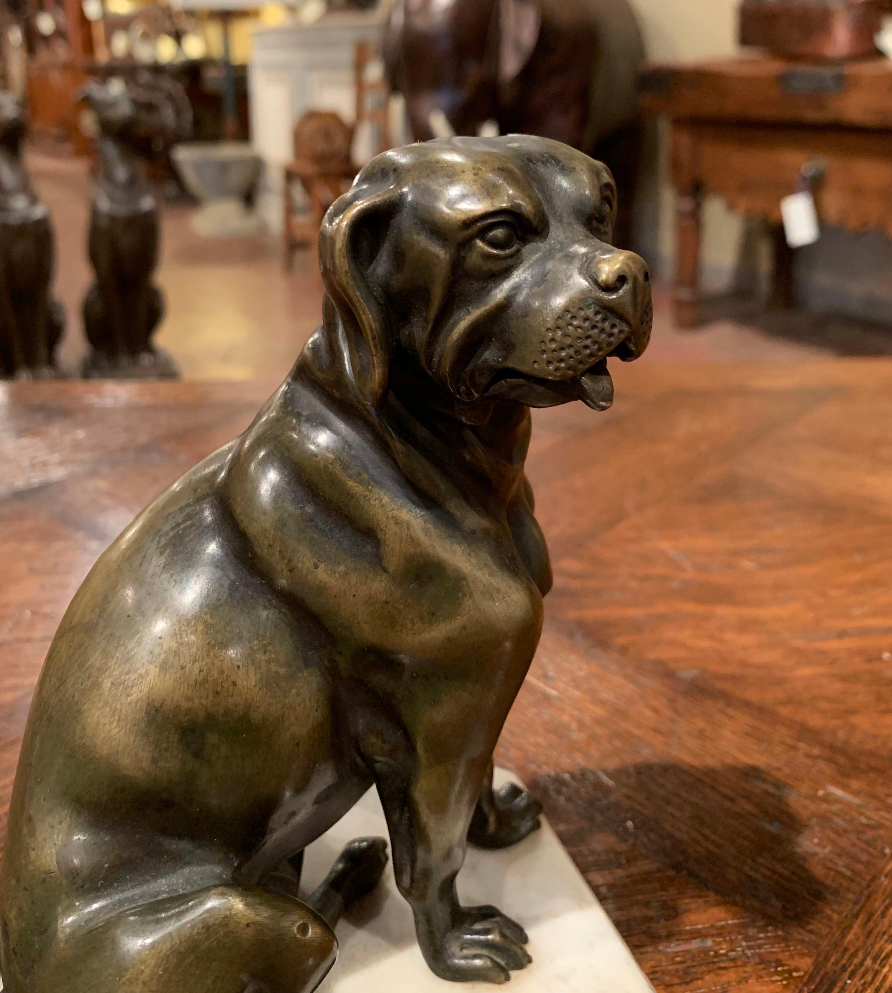 Accessorize a man's office with this antique bronze dog sculpture. Created in France, circa 1890, the sculpture stands on a grey marble top; it features a Dogue de Bordeaux (French bull mastiff), seating on his rear end. The artist conveys action