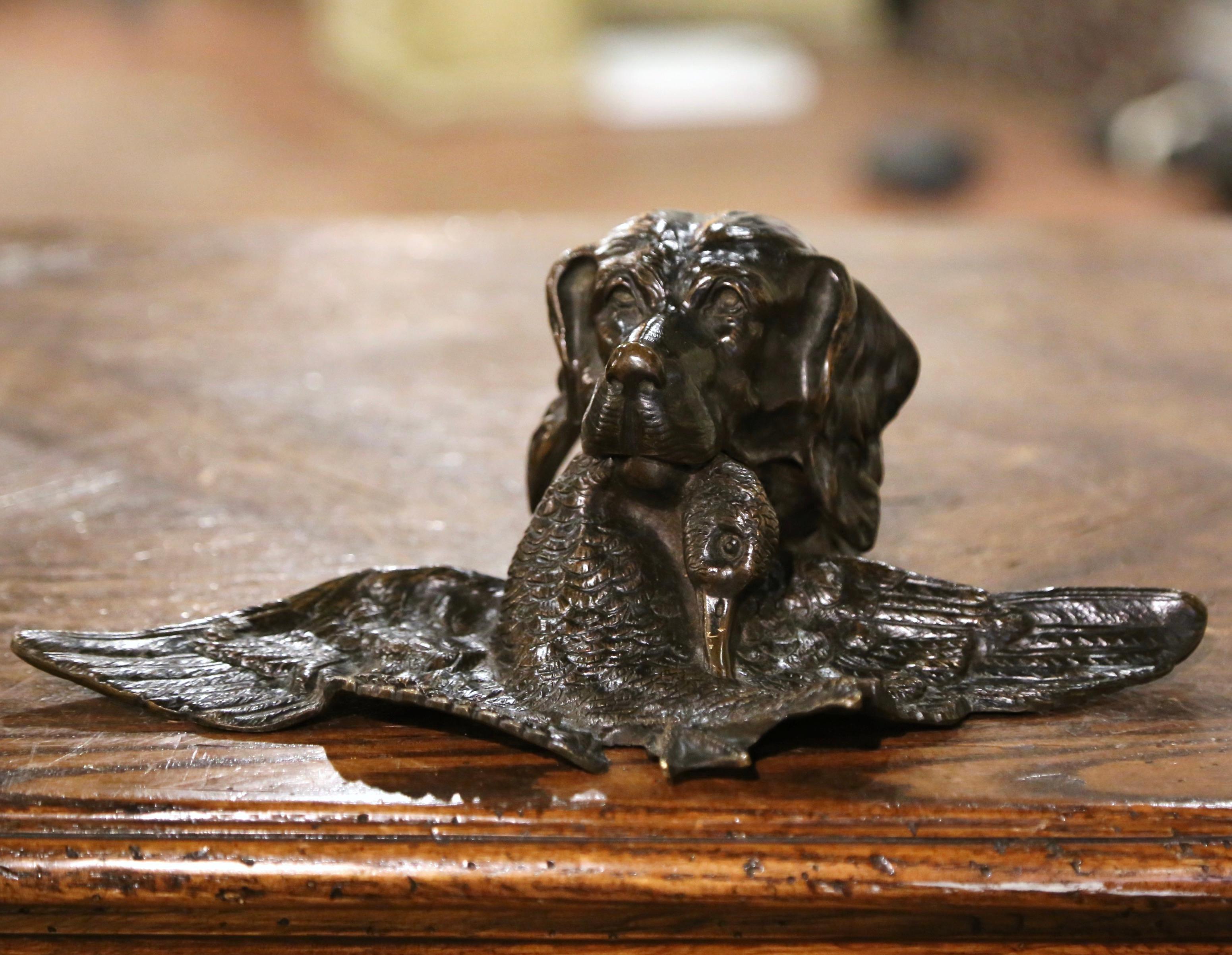 Decorate a man's desk or office with this antique dog and bird inkwell. Created in France circa 1870 and attributed to Jules Moiniez, the sculpture composition depicts a setter head holding a duck in his mouth; the hunting dog face lifts up to