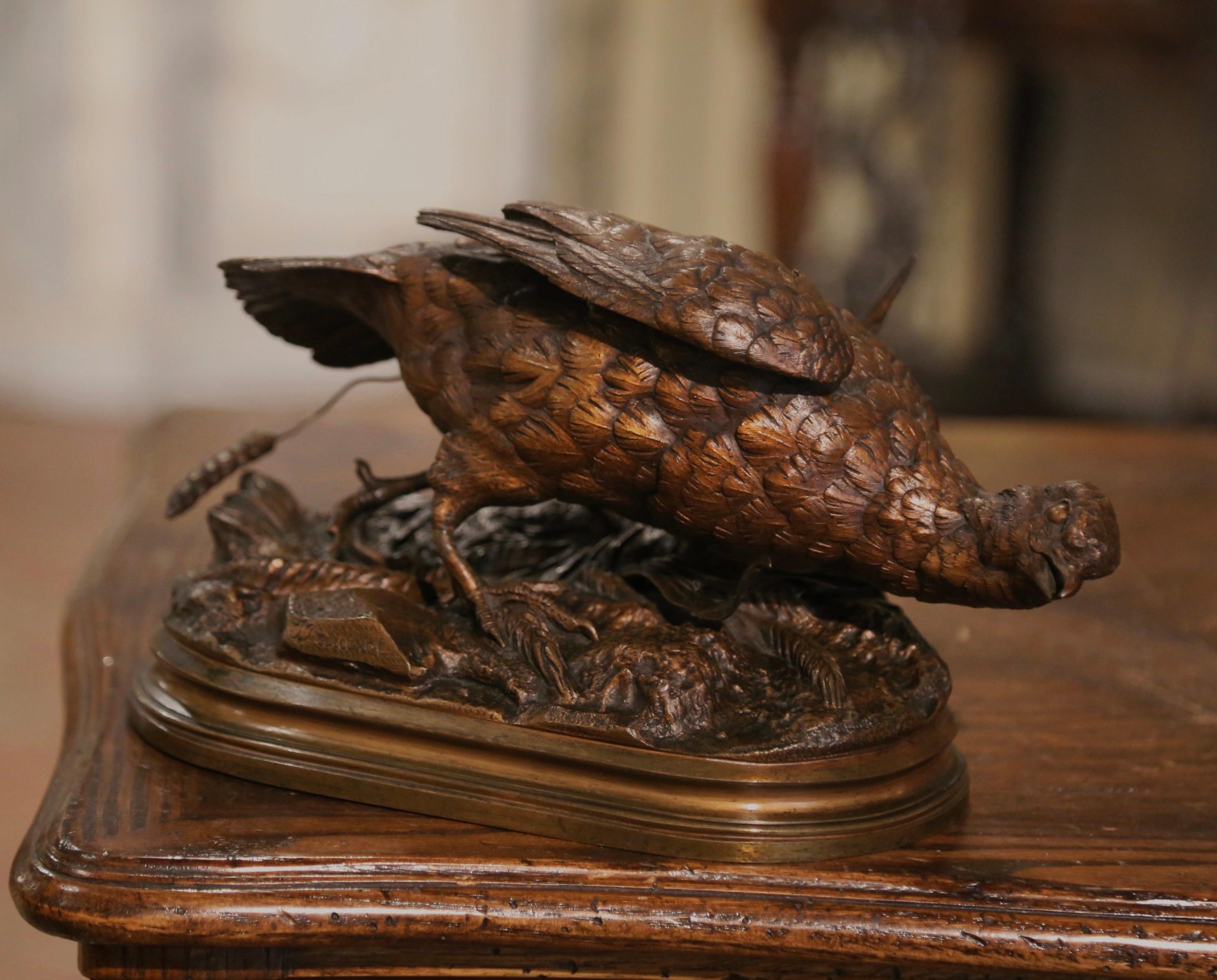Accessorize a man's office or desk with this elegant antique bronze bird composition. Crafted in France circa 1895, the avian sculpture features a pheasant standing on rocky ground covered with wheat stems; the artwork is signed on the base by