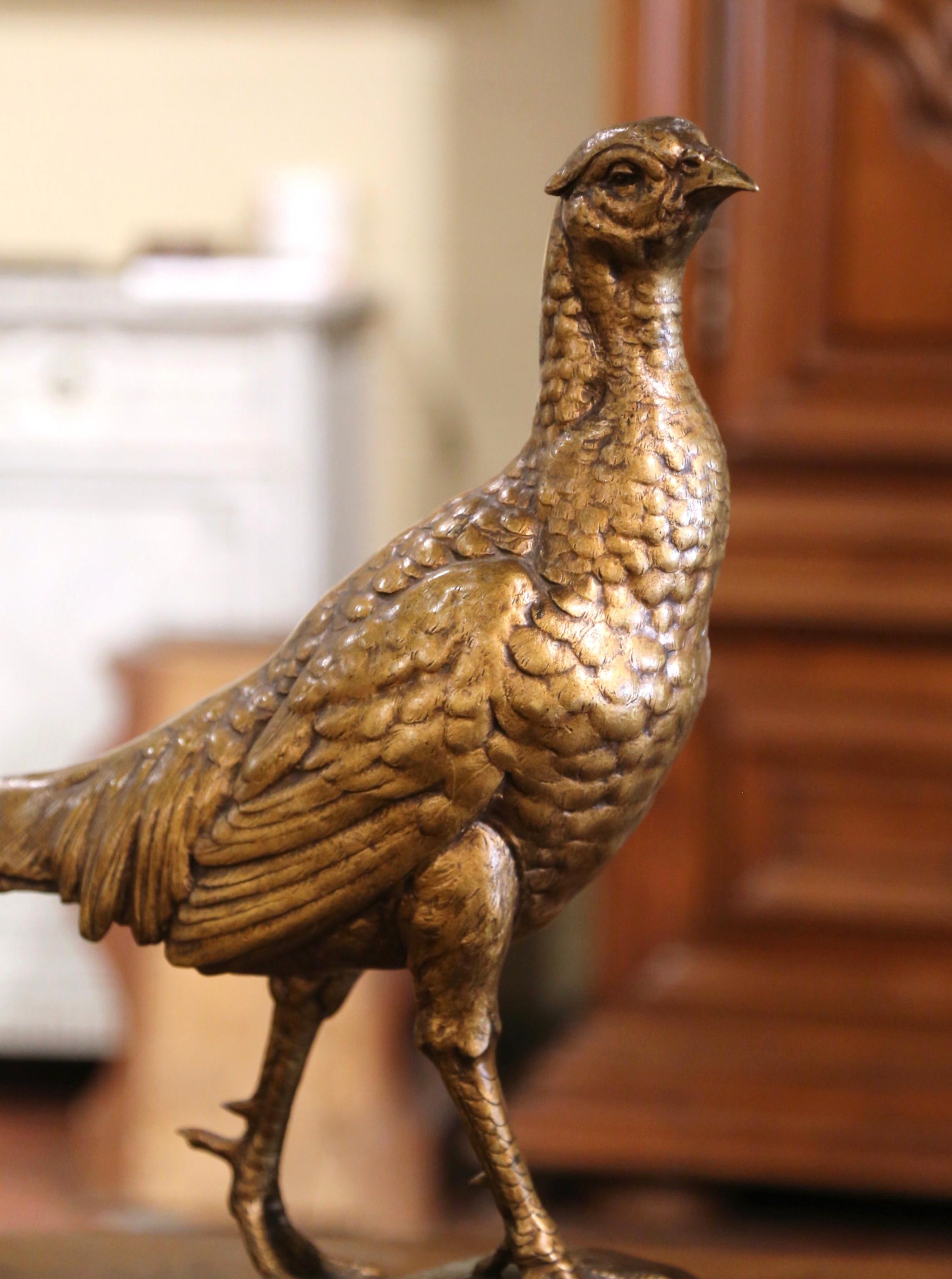 Accessorize a man's office or desk with this elegant antique bronze figure. Crafted in France circa 1895, the large sculpture features a pheasant with long tail standing on rocky grounds; the artwork is signed on the base by French artist J. E.