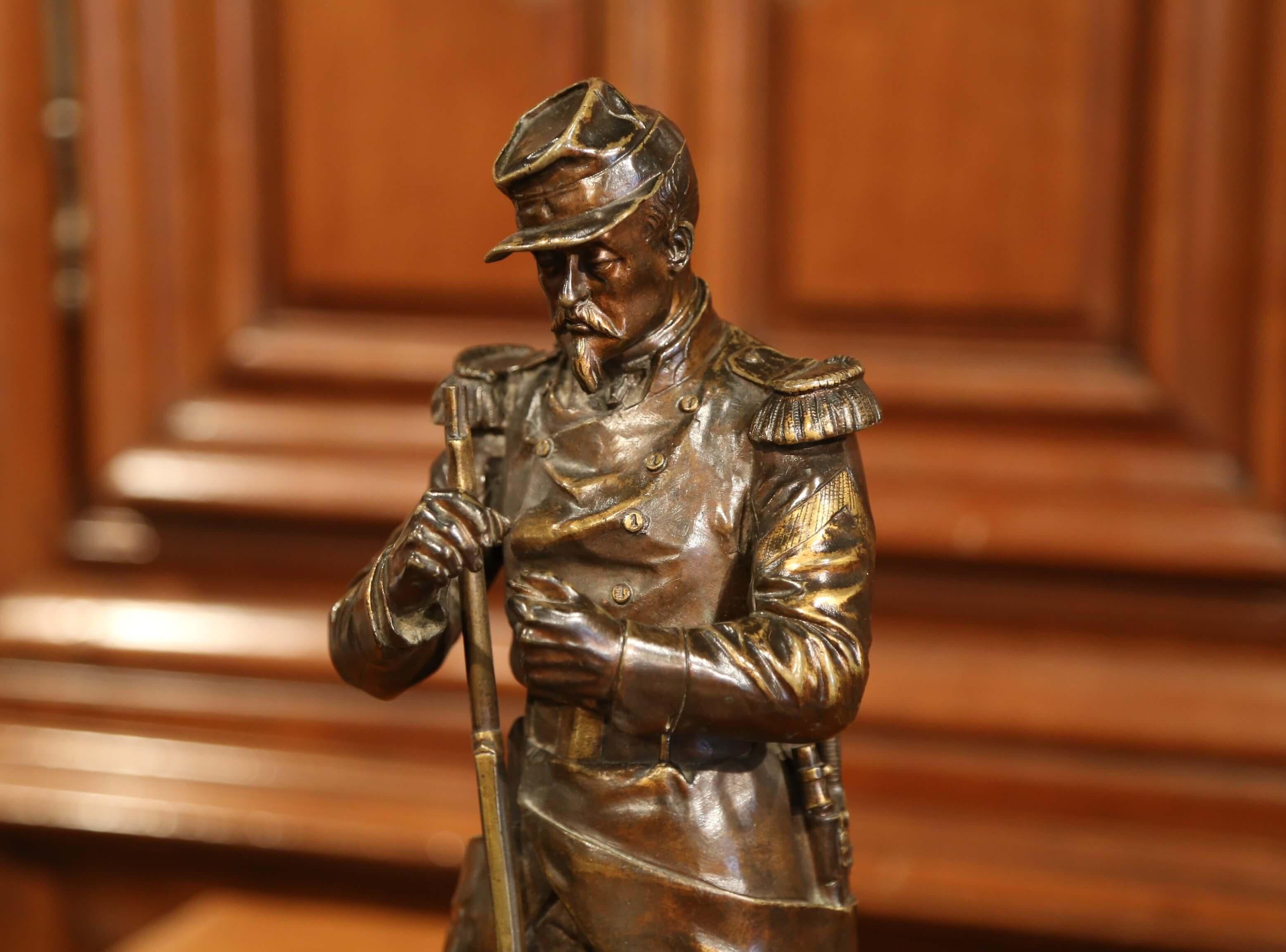 This beautifully detailed bronze figure was sculpted in France, circa 1850. The figural sculpture shows a French soldier in uniform lighting a pipe with his gun by his side, a belt with bayonet and gun powder pouch. The piece called 