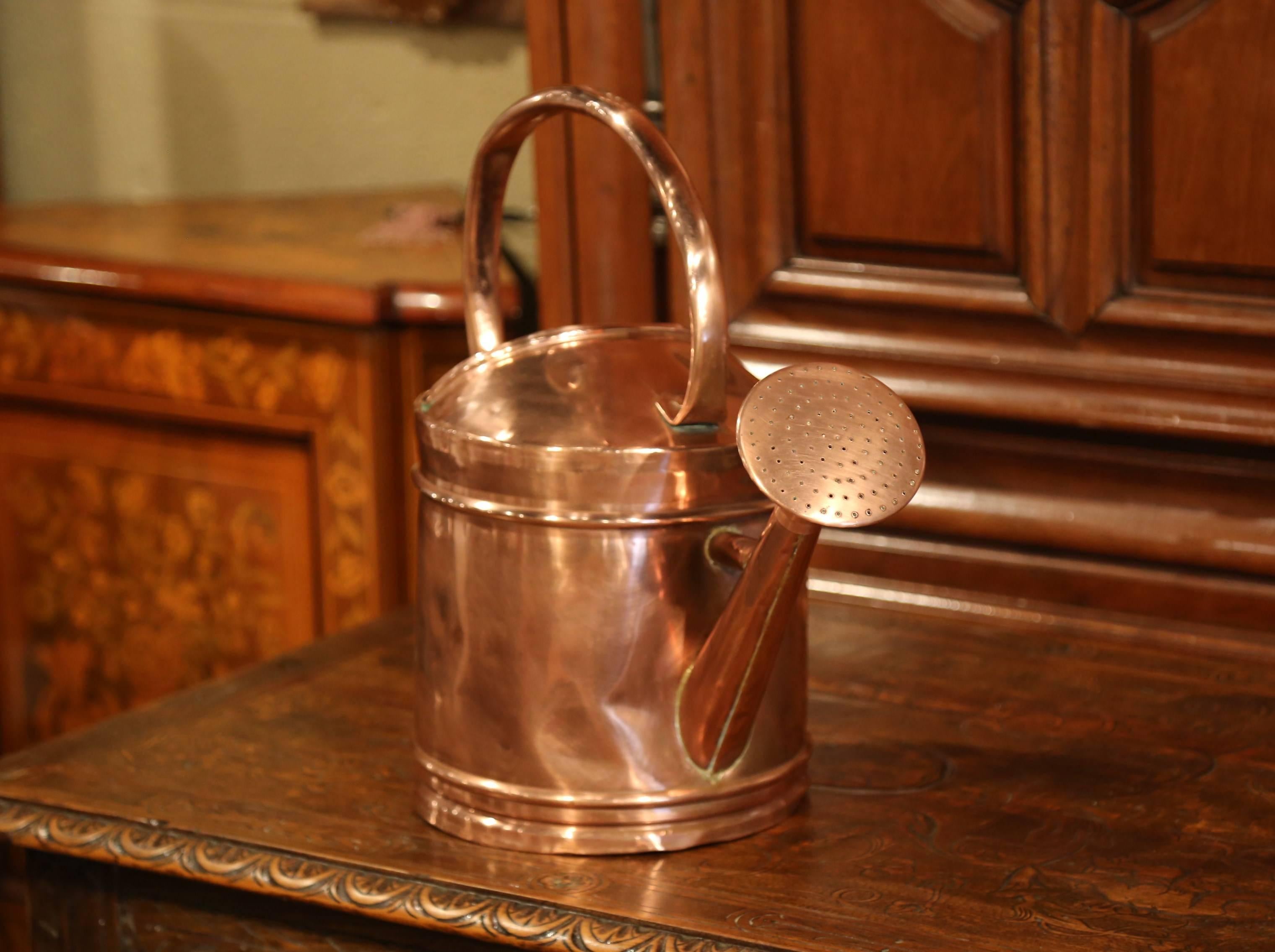 Water your plants elegantly with this antique copper watering can; crafted in France, circa 1860, the can features a removable spout and a large handle for easy use. The piece is in excellent condition with a rich patinated finish.
Measures: 19