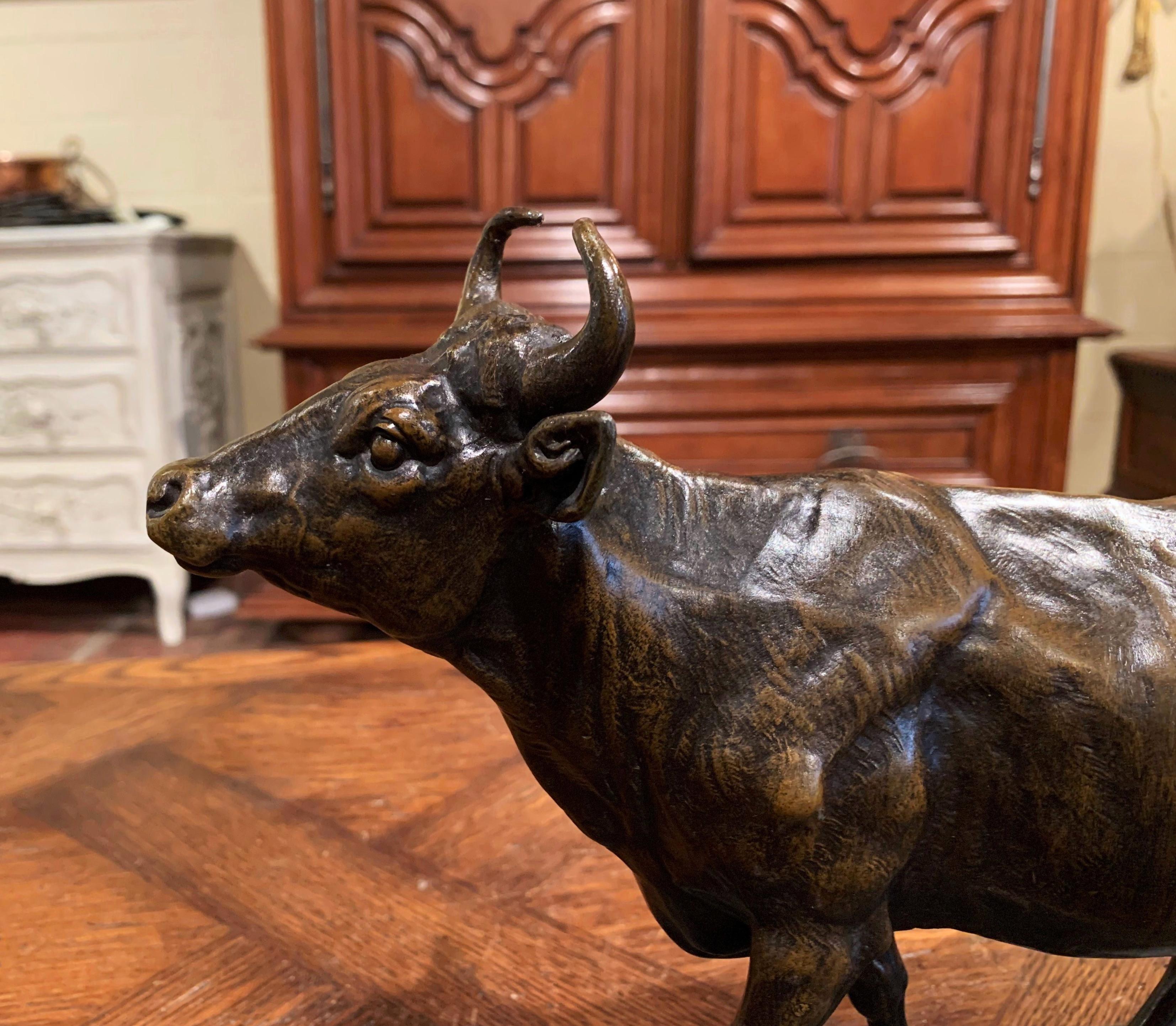 Decorate a man's desk or a library shelf with this antique cow sculpture. Created in France, circa 1890, the spelter figure sits on an integral oval base and depicts a bovine in a walking position. The sculpture is in excellent condition with a rich