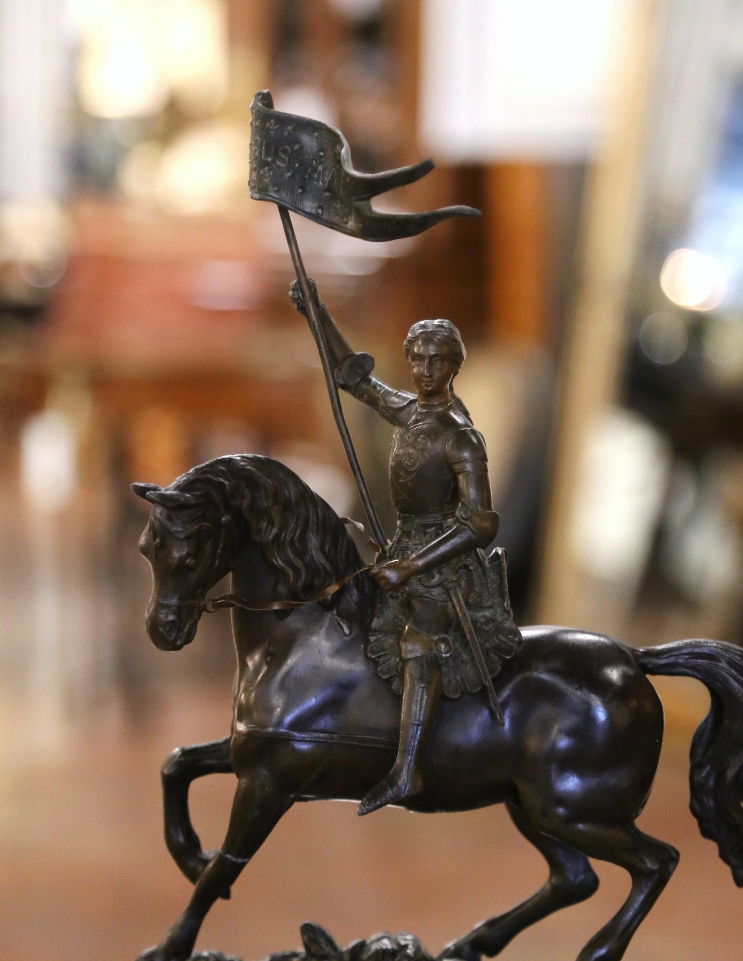 Decorate an office of a study with this elegant statue of Joan of Arc, the iconic French heroine and saint. Crafted in France circa 1870, the antique figure sits on a rectangular base, and depicts Sainte Jeanne d' Arc in armor suit, in a dynamic