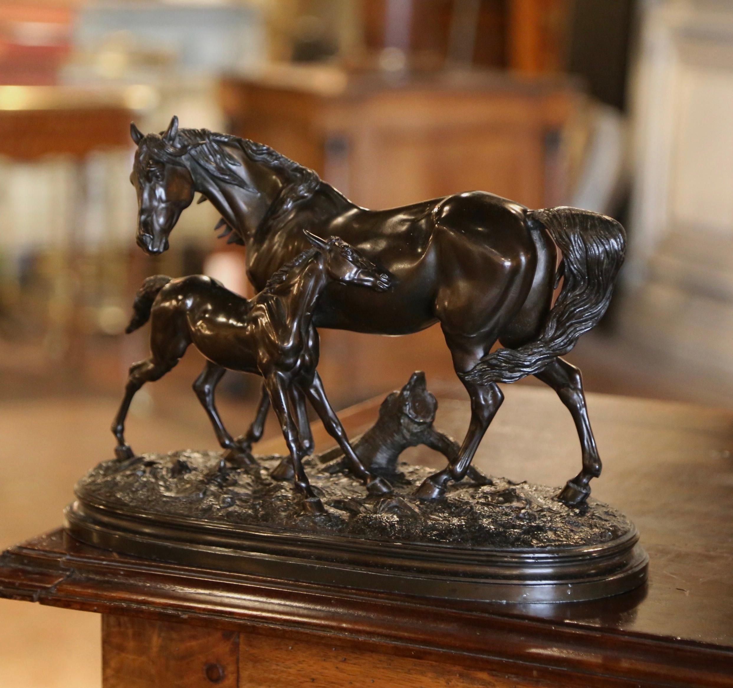 Place this elegant antique horse composition in a man’s office or on a shelf in a study. Created in France, circa 1870, the spelter composition features a tall stallion figure and a foal, both standing on an oval rocky ground base. The piece is