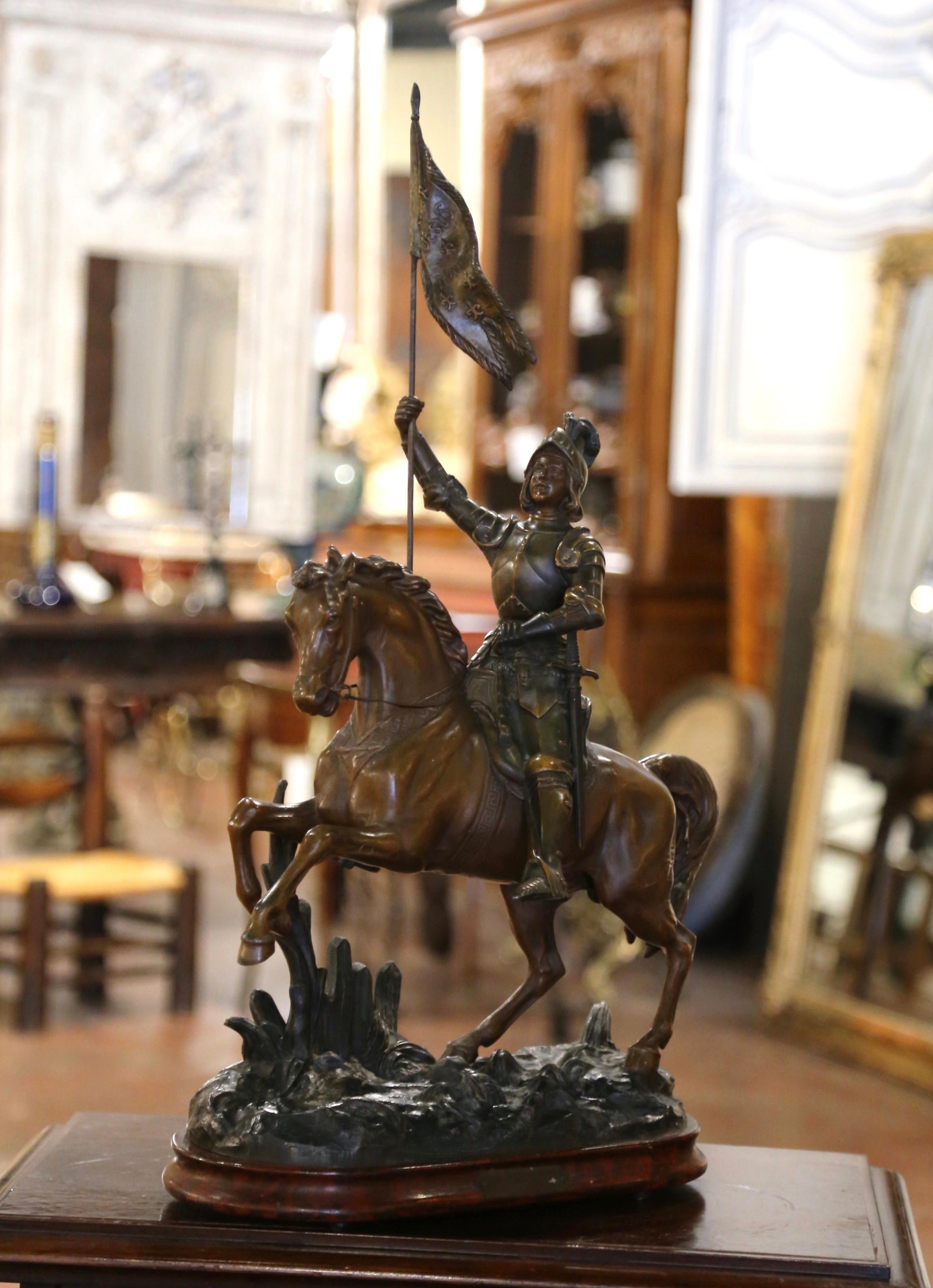 Schmücken Sie ein Büro oder ein Arbeitszimmer mit dieser wunderschönen antiken Statue der Jeanne d'Arc. Die um 1870 in Frankreich gefertigte und auf einem Holzsockel ruhende Figur stellt Sainte Jeanne d' Arc, die ikonische französische Heldin und