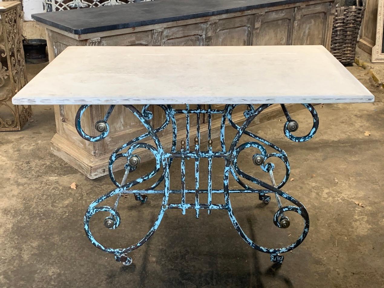A beautiful 19th century French Patisserie table from the south of France. With a lovely wrought iron base which has nice original brass decoration. The original worn paint adds to the overall look and appeal of this beautiful table. The base sits
