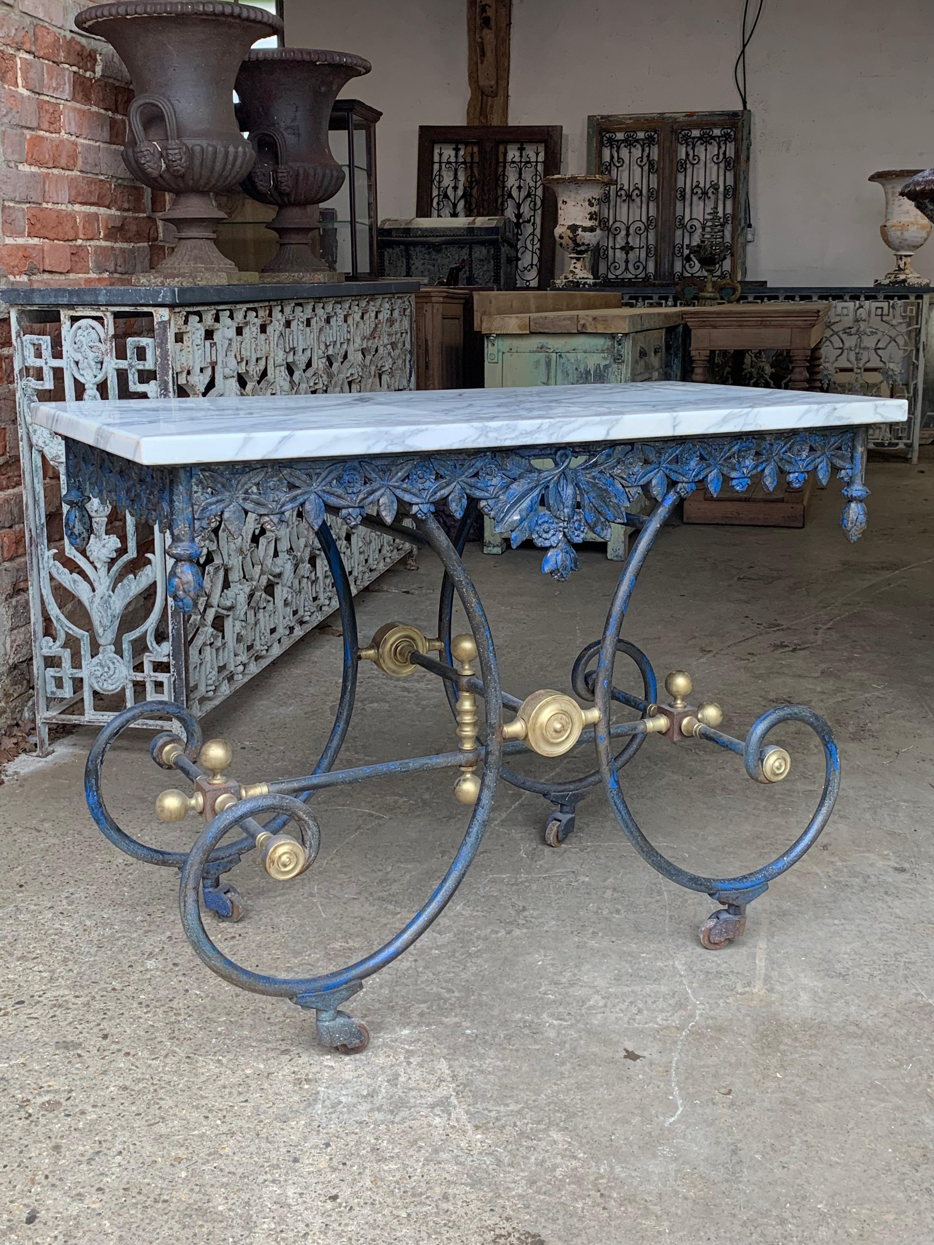 A beautiful late 19th century French patisserie table with lovely old worn paint and solid marble top. It has a wonderful decorative iron frieze around the top which is all complete and undamaged.

This type of table was used to display cakes in the