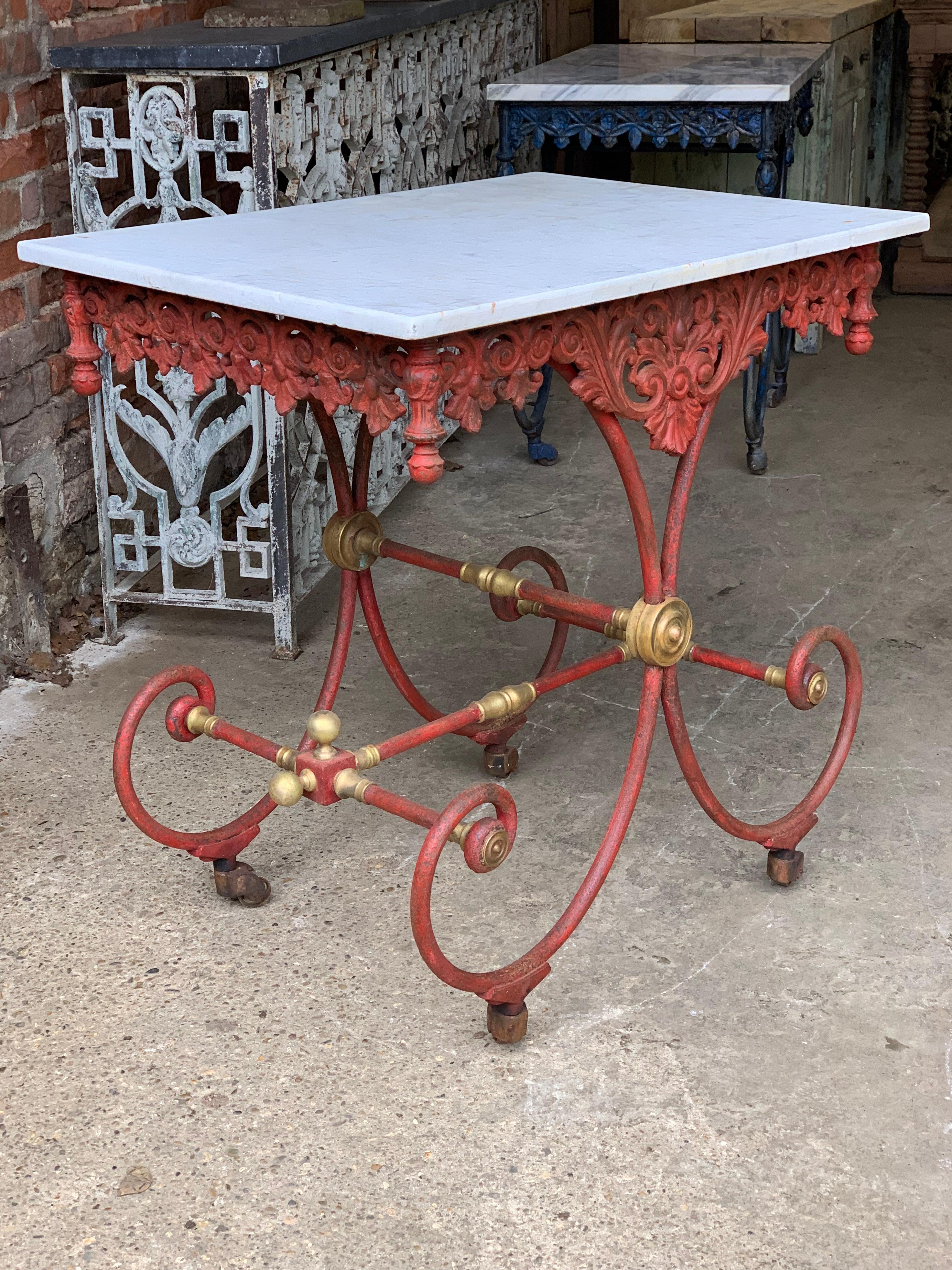 A beautiful 19th century French patisserie table with an iron base and original marble top. It has lovely old worn paint giving it a great look. These style of tables were used to display cakes in the patisserie shops of France.