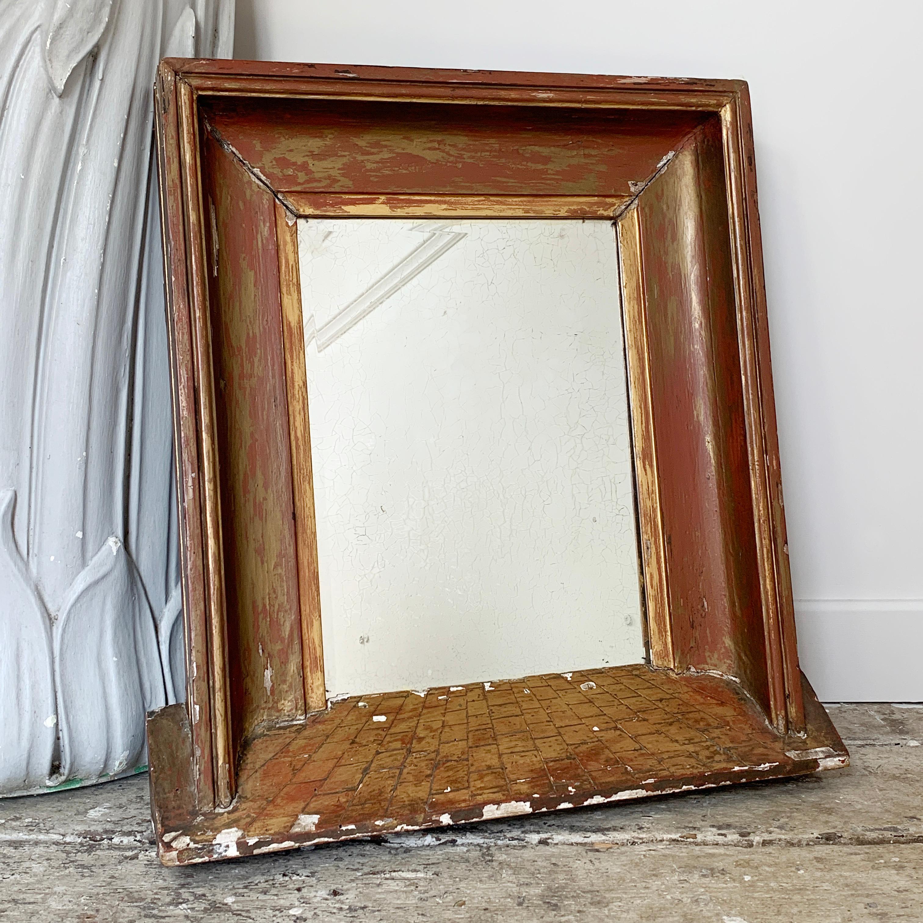 A wonderfully proportioned, deep frame perspective mirror, made in France in the early 1800s, the mirror is wood and gilt gesso. The design is in the 'travail de brique' manner and gives the frame and bevelled foxed plate a charming and engaging