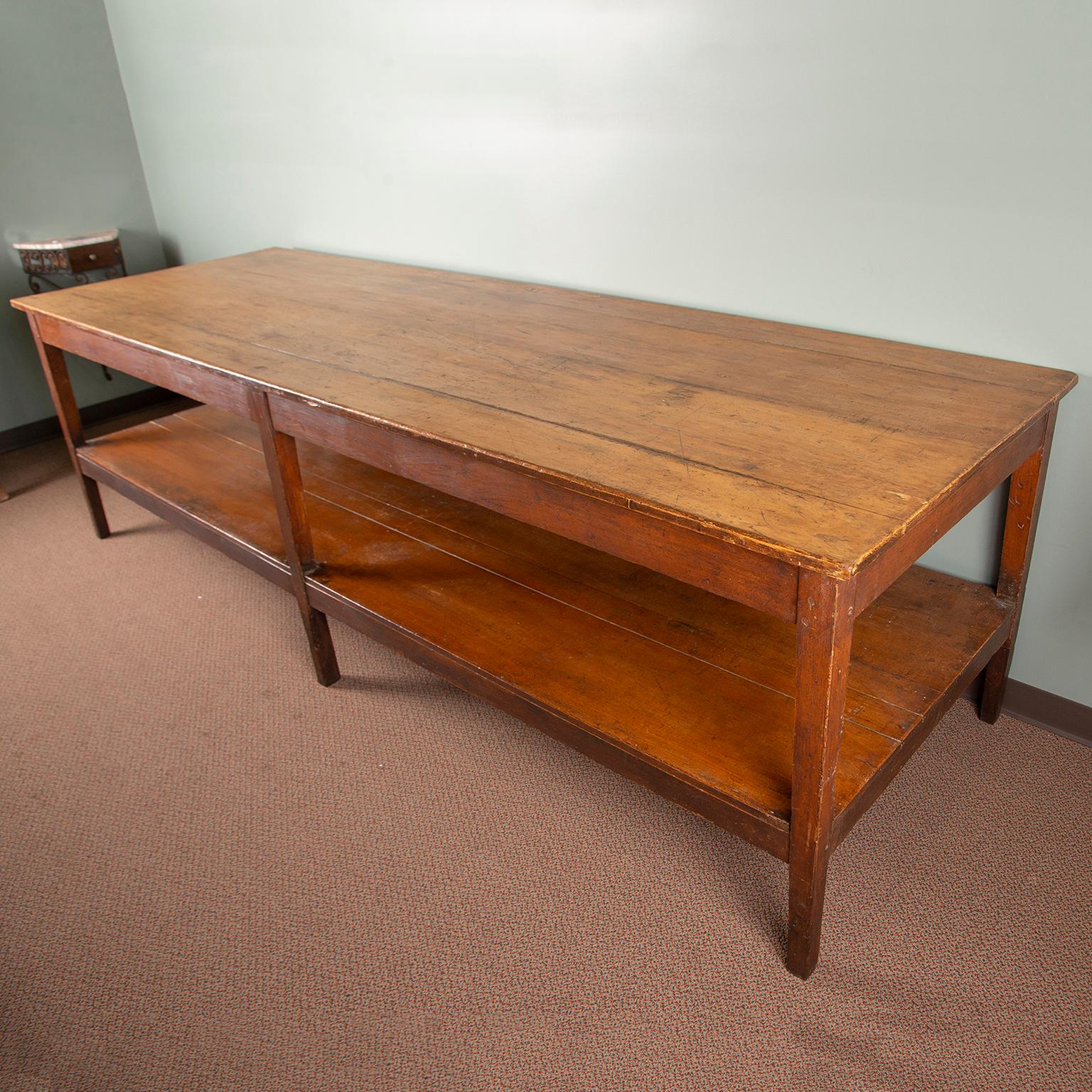 19th century French drapers table is made of pine and retains its original finish. This over-sized working table was originally used by seamstresses to lay out, cut and measure fabric. Now this makes a great dining or work table. Very sturdy with