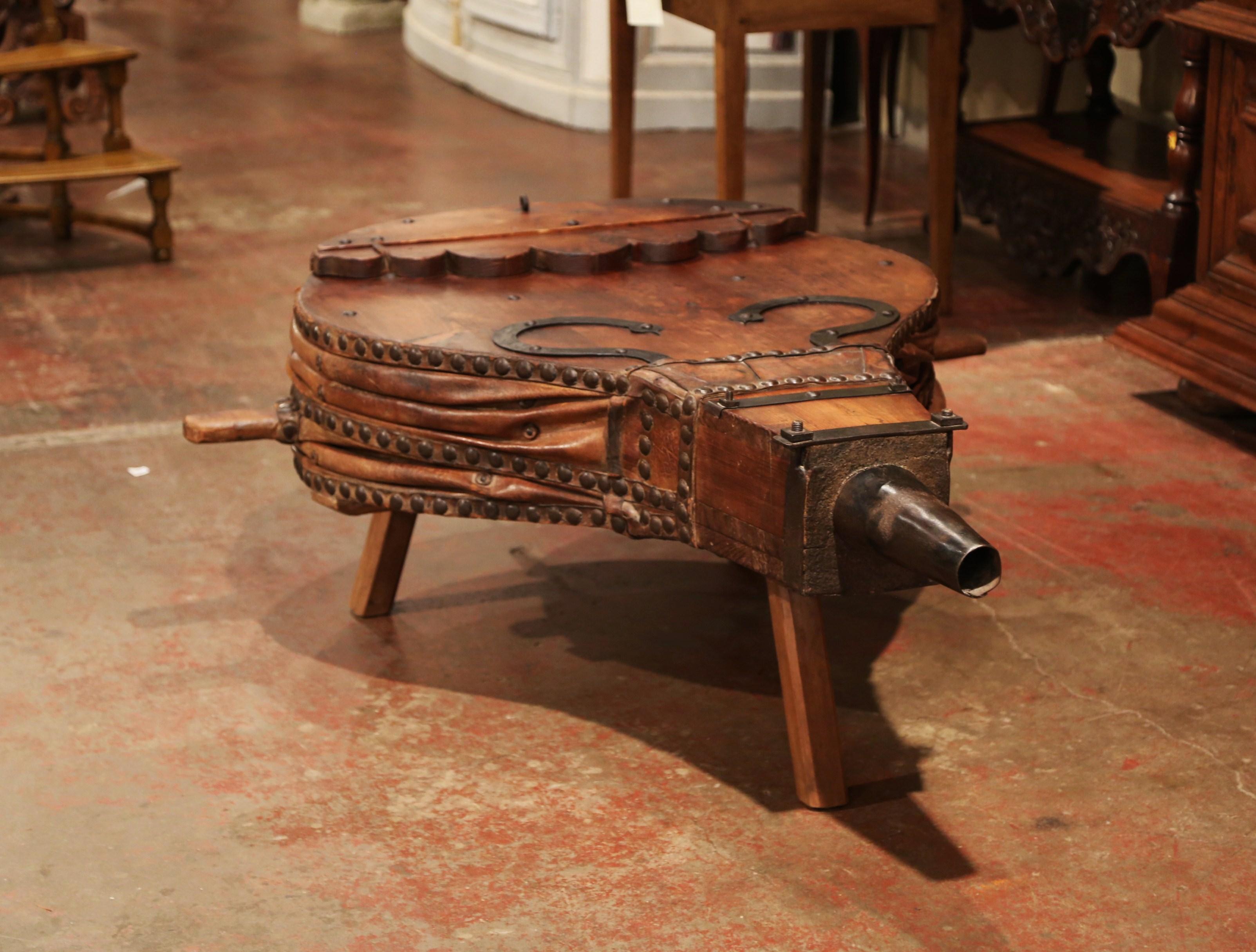 Decorate a ranch den or a country living room with this large antique blacksmith's bellows, which has been retrofitted as a coffee table. Crafted in France circa 1850, the piece sits on three legs and features its original accordion leather with