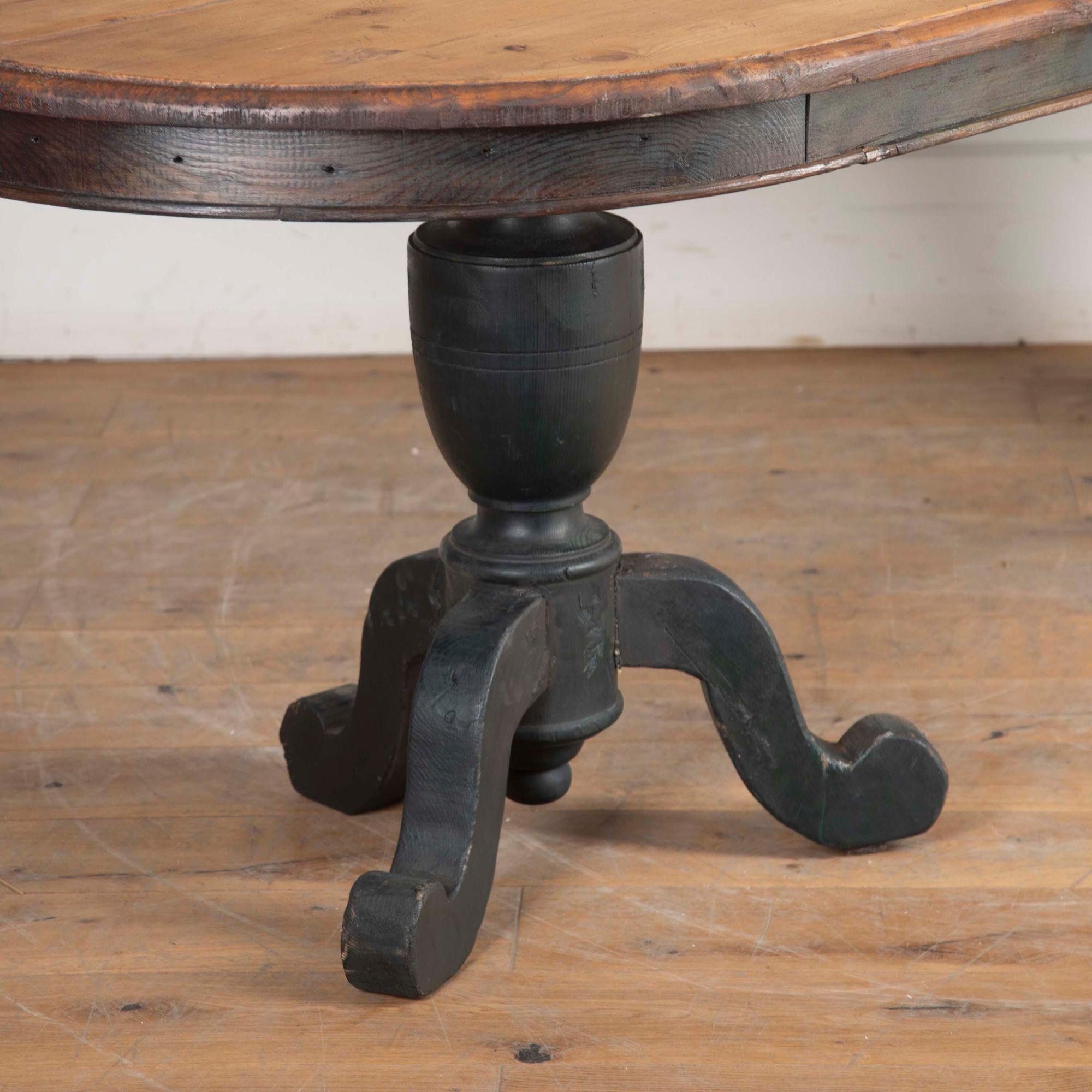 Large 19th Century oval pine table on two black-painted tripod pedestals.
The pedestals can be unscrewed for ease of transport. 
With a warm colour and patina to the top.