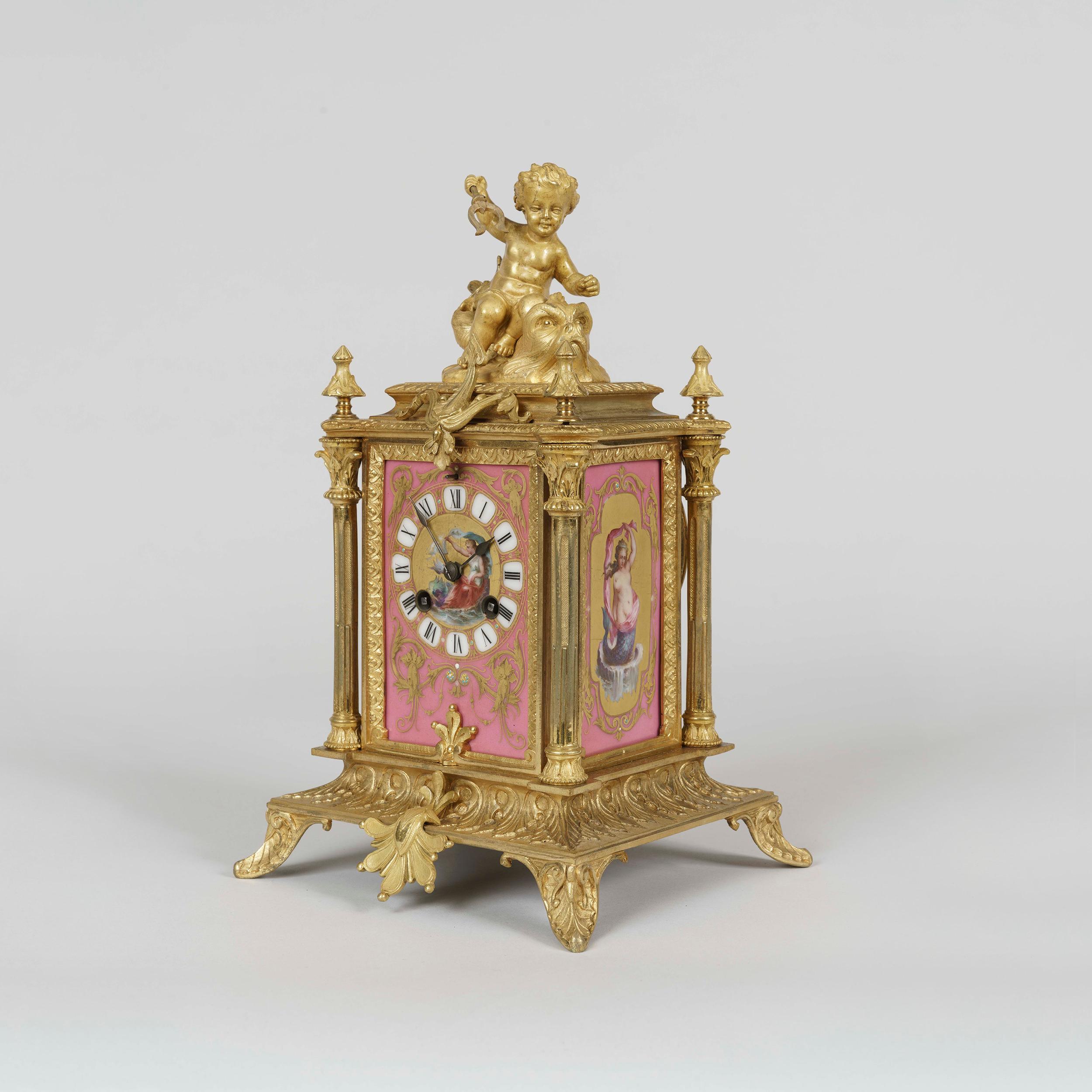 A table clock in the Louis XVI Manner
By Japy Frères

The finely chased ormolu case is dressed with pink 'Sèvres' style hand decorated polychrome panels to the face and sides, depicting Venus and Nereids respectively; the clock having fluted
