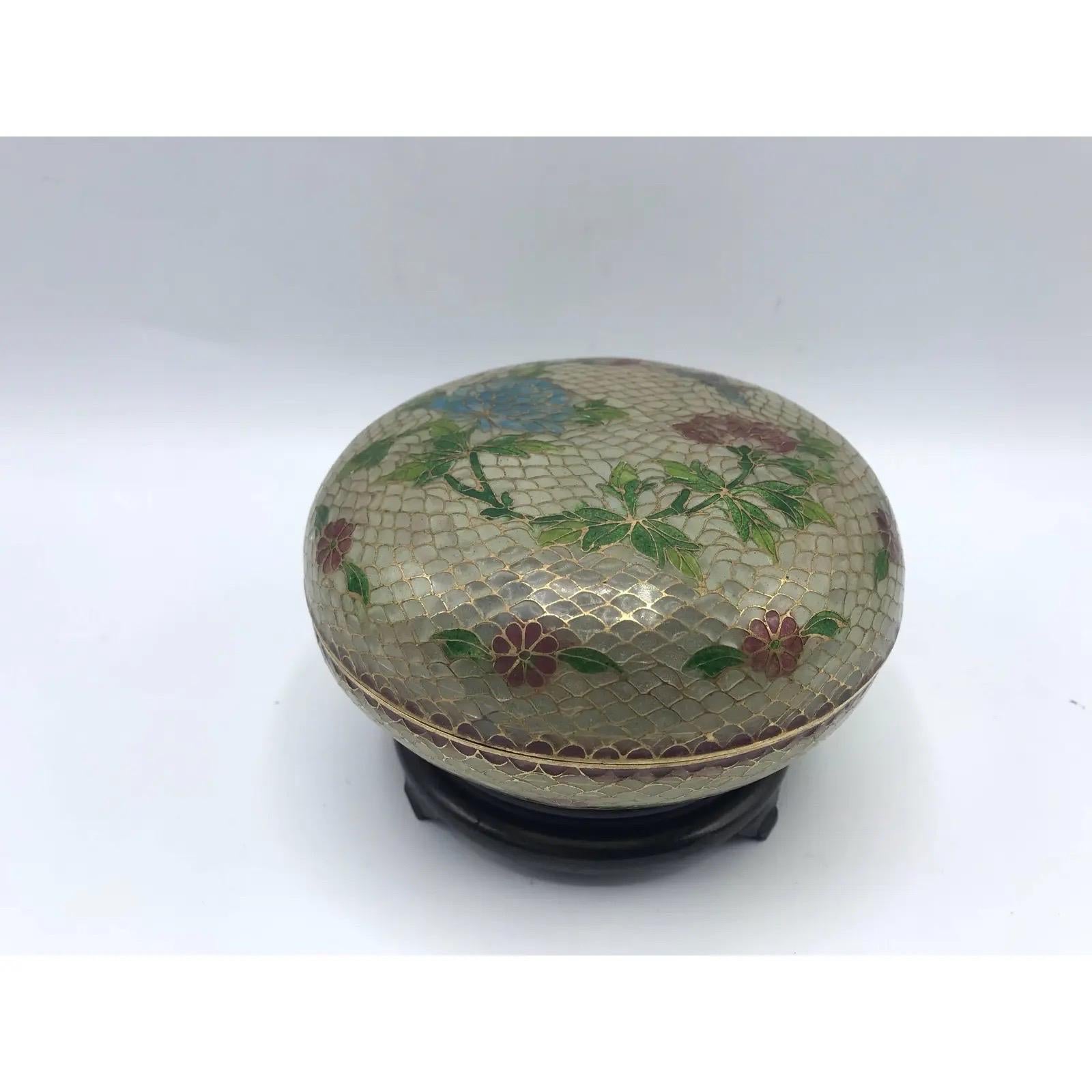 Offered is an exquisite, late 19th century French Art Nouveau, Plique a Jour cloisonné-enamel lidded bowl on a decorative wood stand. The piece has a gorgeous butterfly and floral-inlaid motif all over.

Dimensions:
With stand, 3.75” tall. 
Without