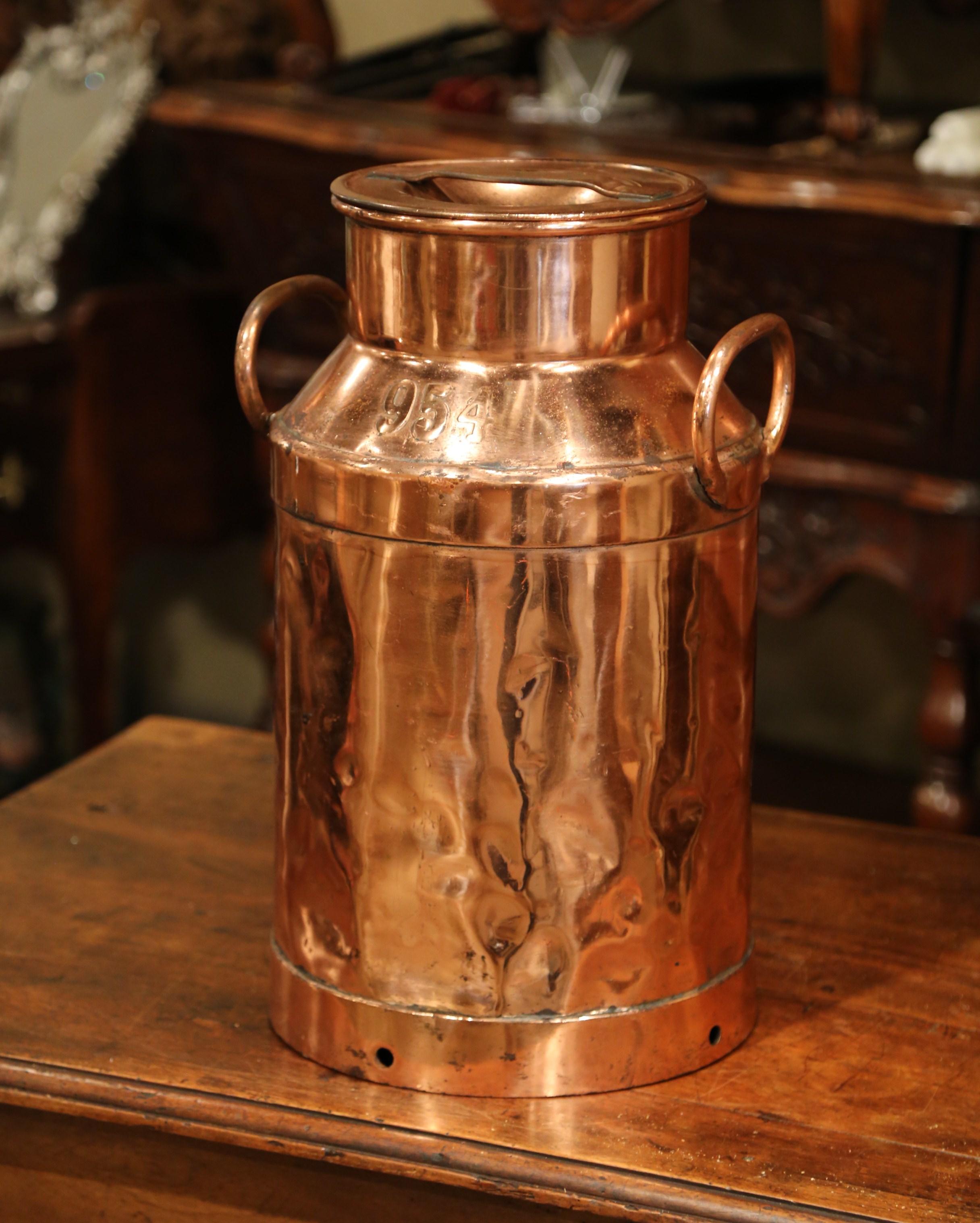 Use this beautiful antique milk can as an umbrella stand by your front door. Crafted in France circa 1880, the tall metal and copper container has side handles and its original removable lid. The traditional, utilitarian urn is branded with the