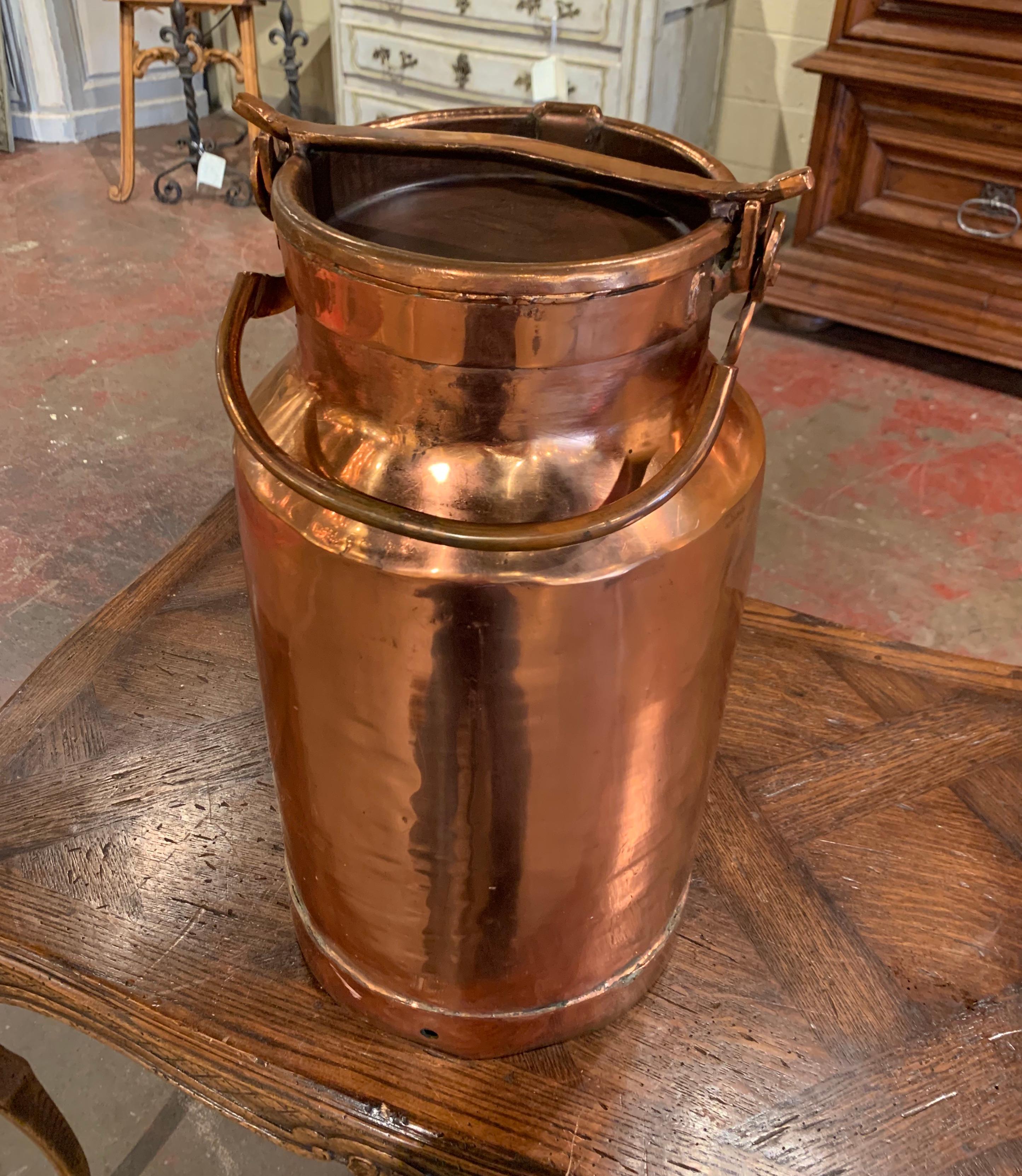 Use this beautiful antique milk can as an umbrella stand by your front door. Crafted in France circa 1880, the tall copper container has side handles and its original removable top. The large and heavy pot is in excellent condition with a few dents,