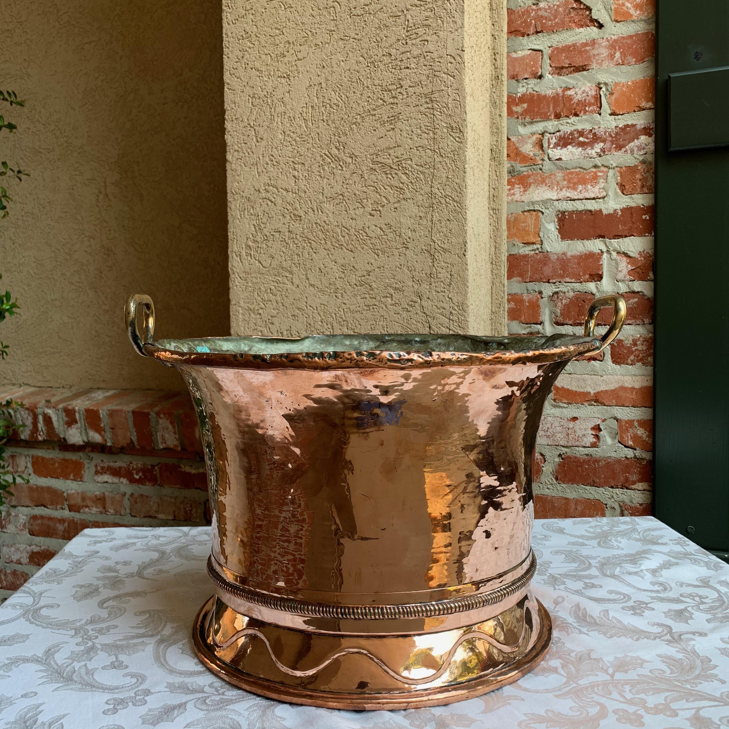 ~ Direct from France
~ Large antique French copper jardinière/planter!!
~ Tall round pot, with raised ribbing above the stepped out base band with a raised serpentine design and rolled lower edge
~ Large Riveted brass fixed handles on both