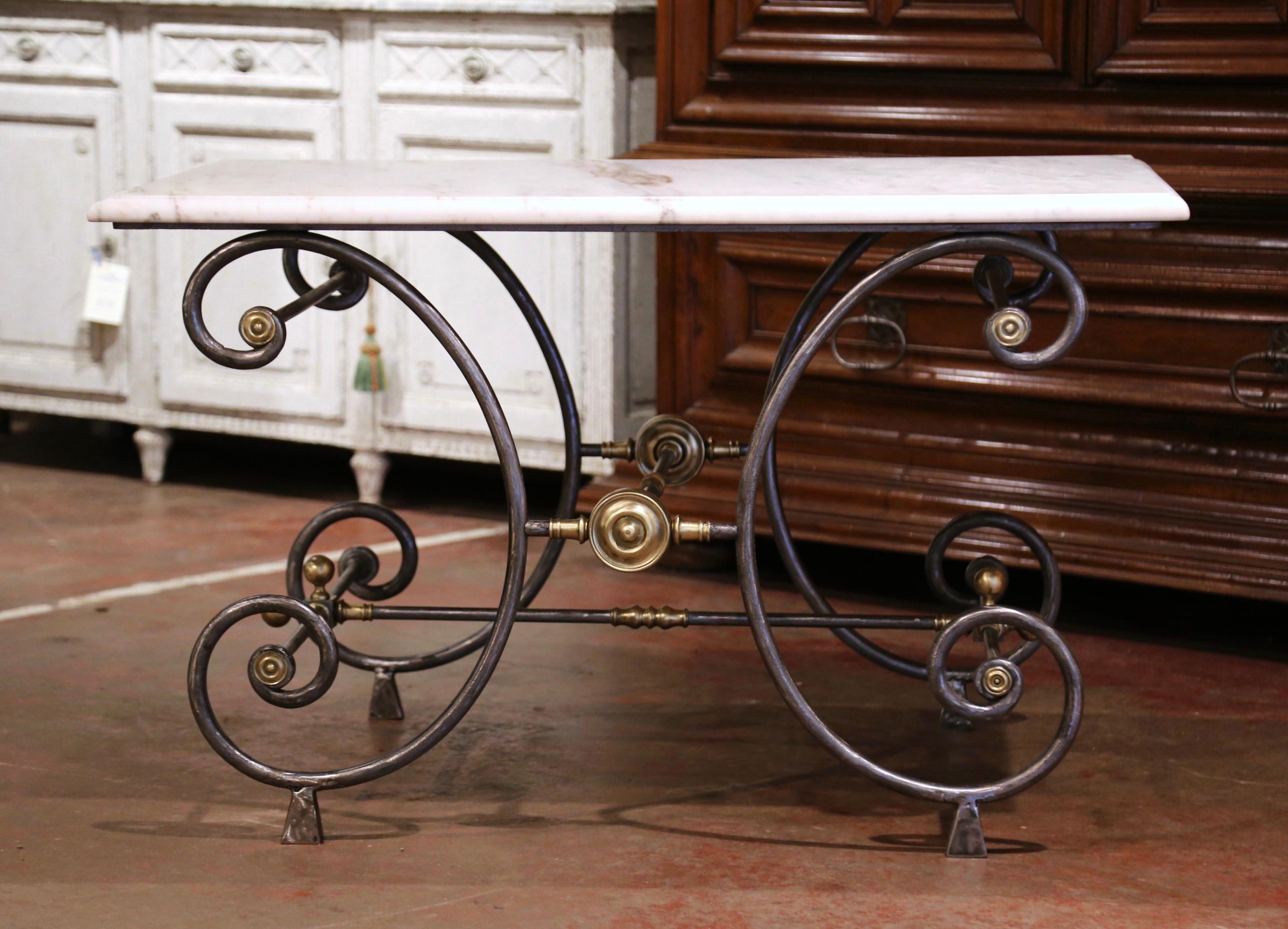 Rectangular in shape, the antique butcher table (or pastry table) would add the ideal amount of surface space to any kitchen. Crafted in France circa 1880, the table features intricate metal work and beautiful scrolled legs, decorated with round