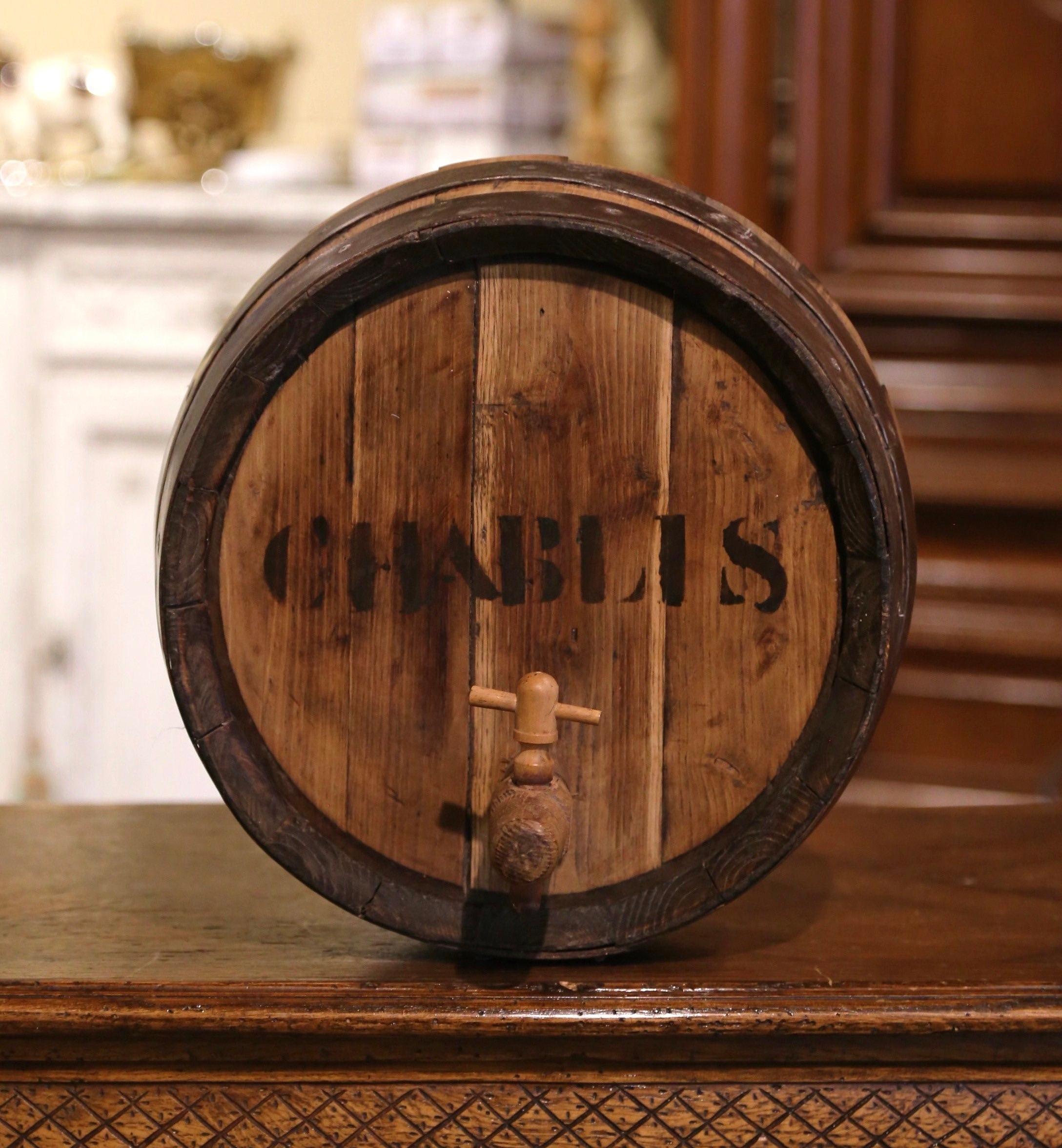 Decorate a wine cellar with this antique wine barrel. Created in the wine Bordeaux region of France, circa 1880, the decorative piece a wine barrel top made of oak and strapped with the original metal; the round top is embellished with painted words