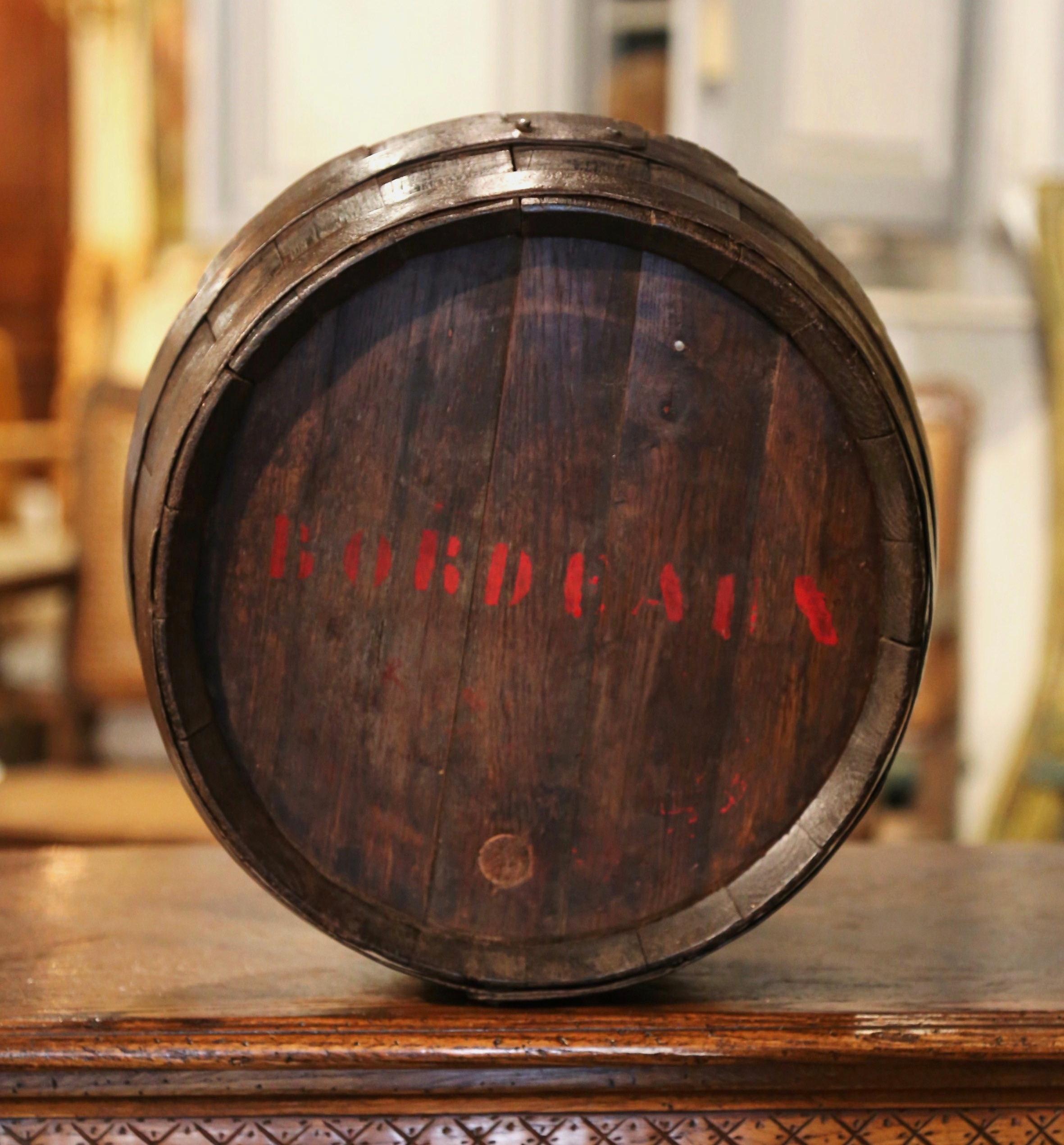 Decorate a wine cellar or a bar with this antique wine barrel. Created in the wine Bordeaux region of France, circa 1880, the decorative piece features a wine barrel top made of oak and strapped with the original round metal bands; the circular top