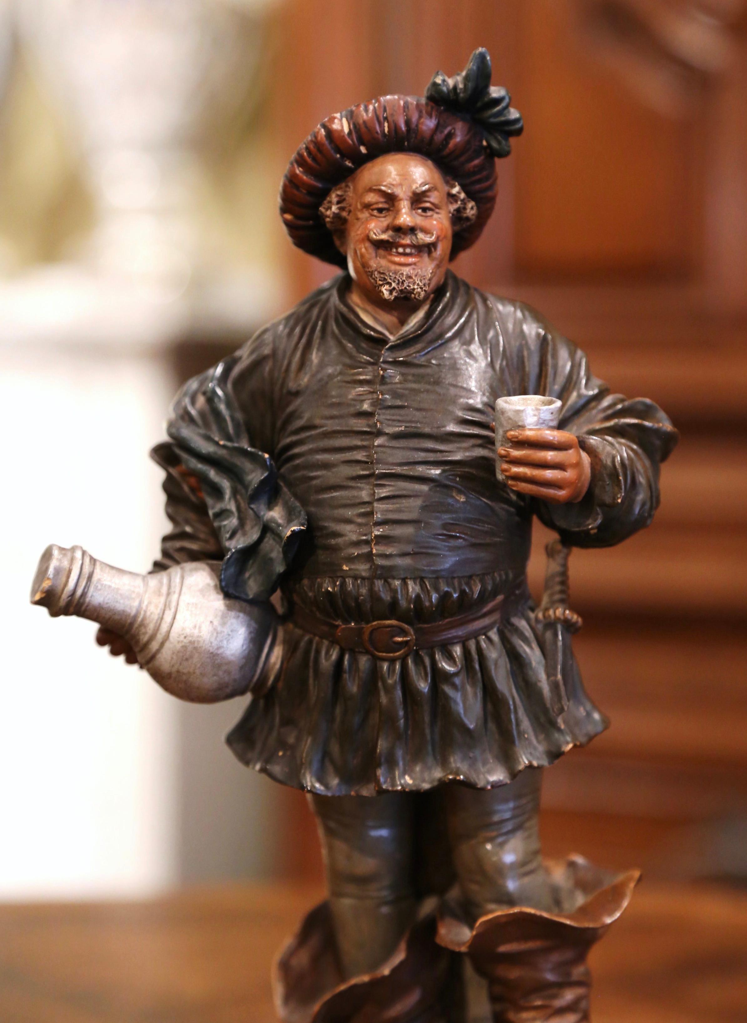 Accessorize your wet bar or wine cellar with this antique musketeer terracotta figurine. Created in Northern France, circa 1890, the 