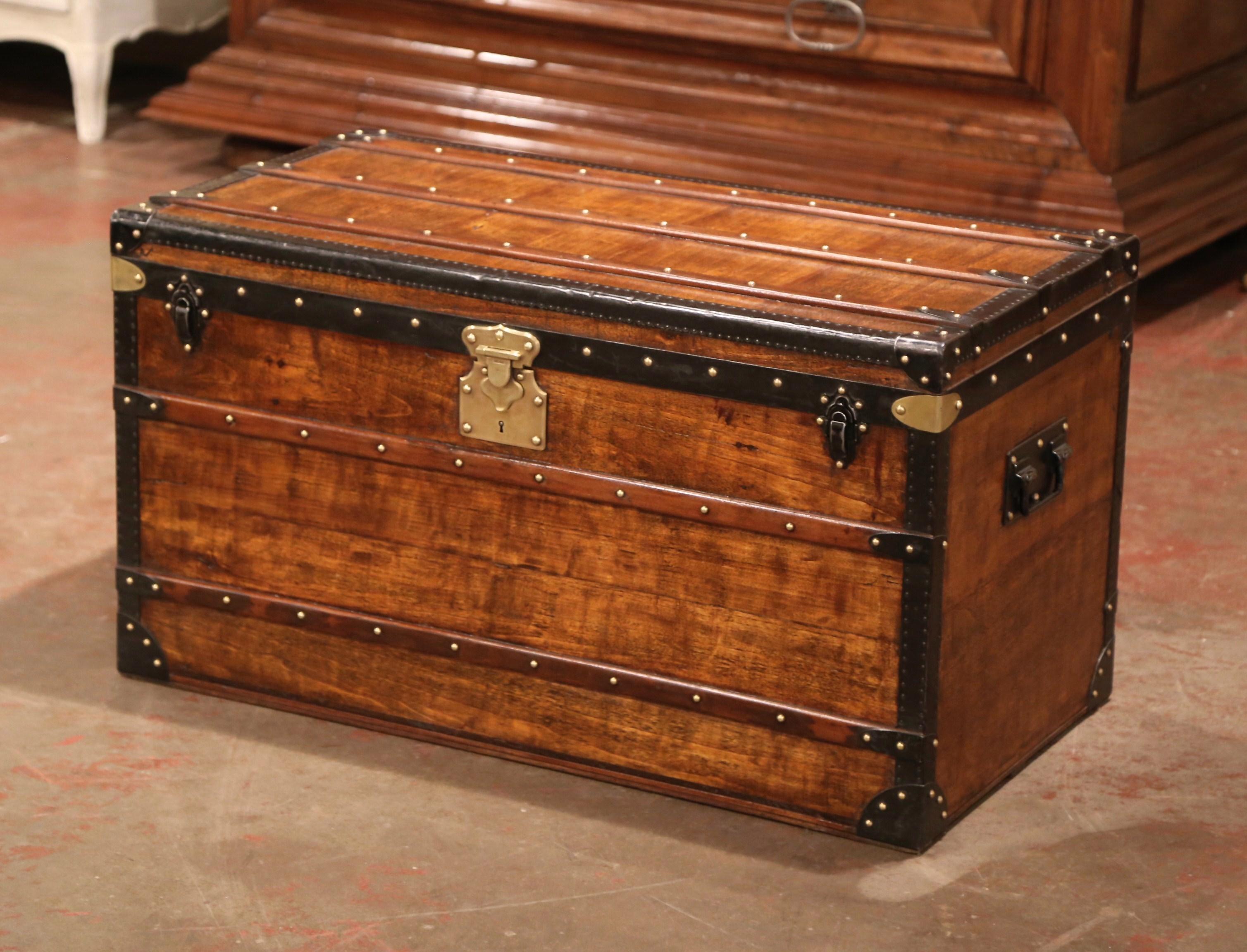 Rectangular in shape, this beautiful suitcase would make an elegant coffee table; crafted in Paris near the Champs Elysees, circa 1890 by Alexandre Velay, the fruitwood trunk with handles is finished on all four sides; it features decorative brass