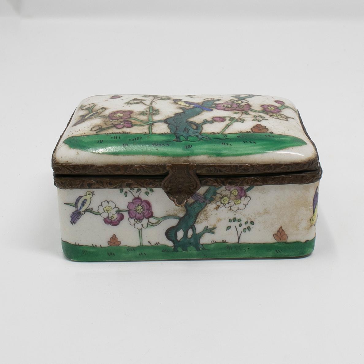 19th century French porcelain and brass trinket box with flower decorations.