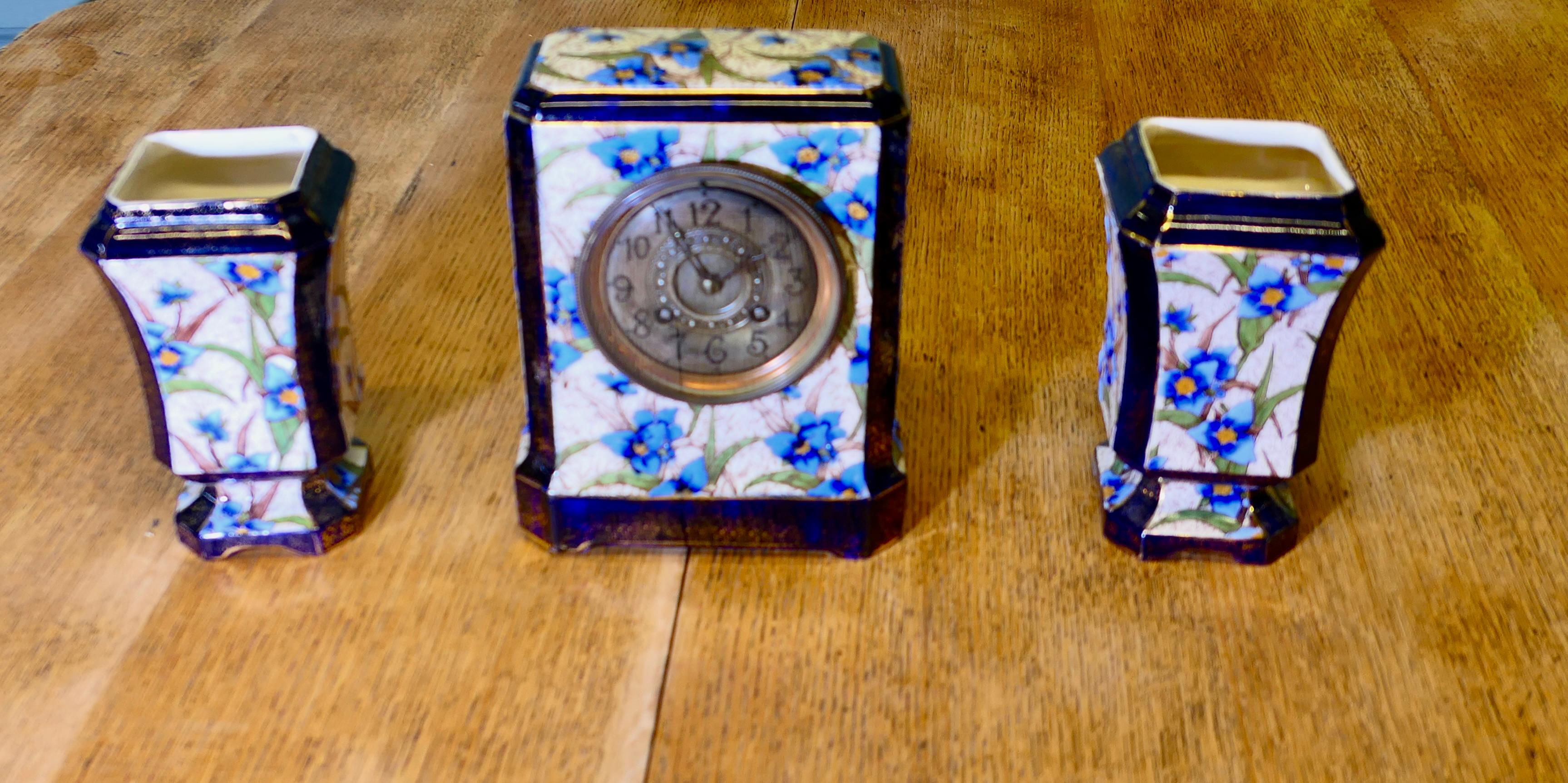 19th Century French Porcelain Clock Set
The clock is housed in a beautiful Porcelain case decorated with blue flowers and has a pair of accompanying vases, the clock movement is working but could probably do with cleaning.
The ceramics are all in
