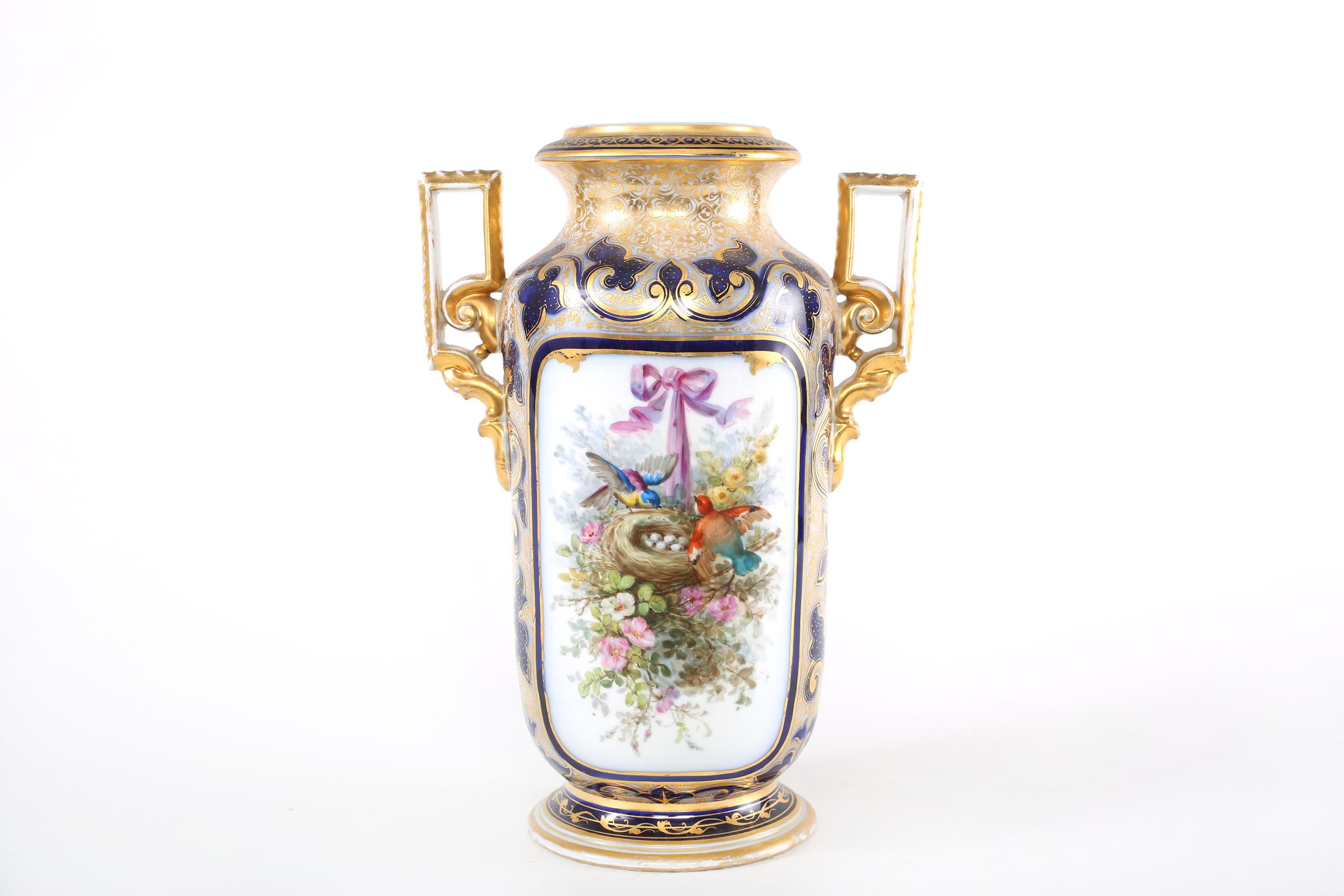 Mid 19th century French porcelain decorative vase / piece with exterior gilt gold painted scene design details and side handles. The vase / piece is in good condition with appropriate wear consistent with age / use. The vase / piece stands about 17