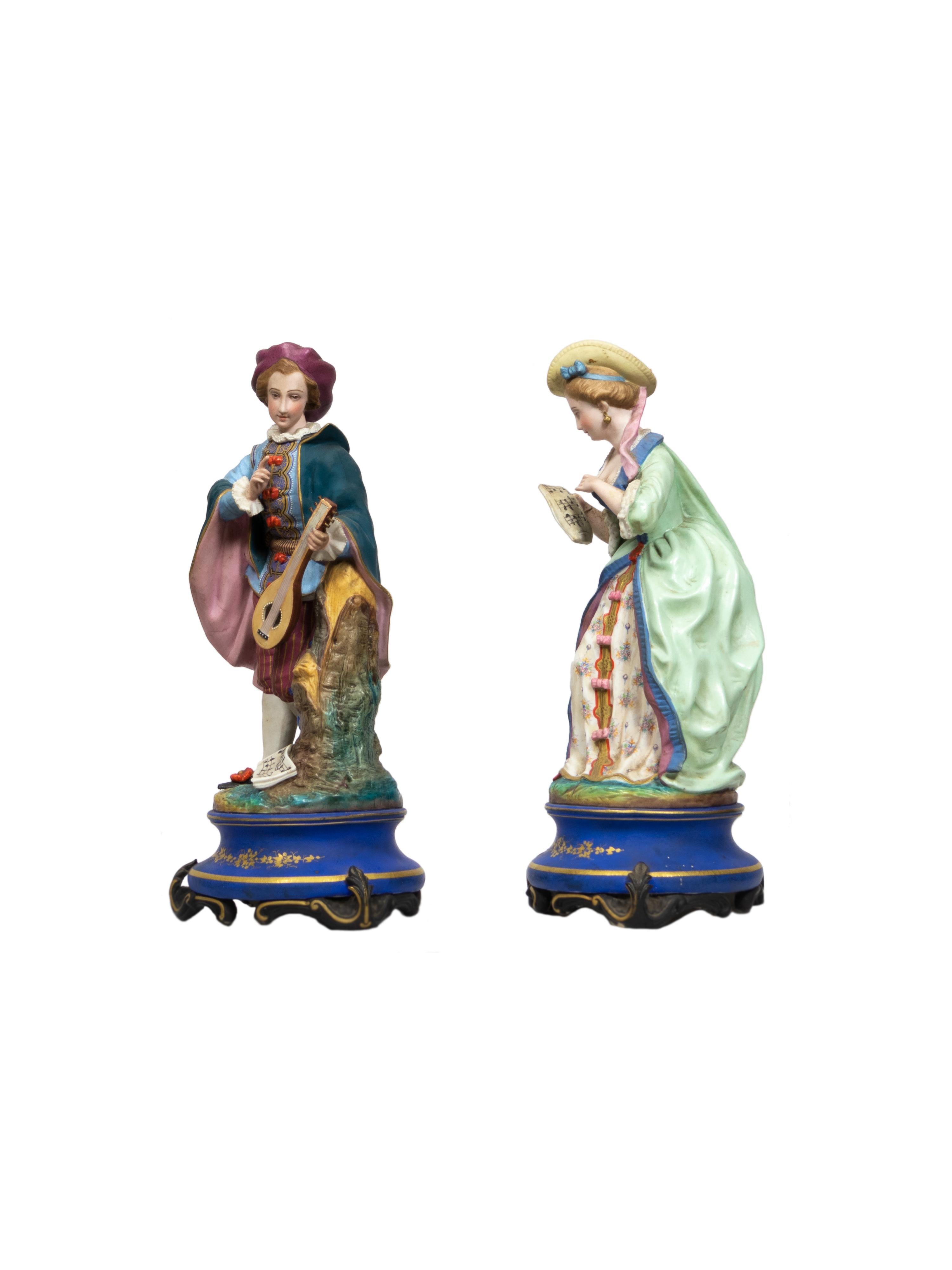 A large pair of French polychrome and gilt painted biscuit figurines of a mandolin player and a singer.
The woman is wearing a green sack-back gown with white flowery etched inner dressing and elegant side hat.
The man is dressed in Rococo style:
