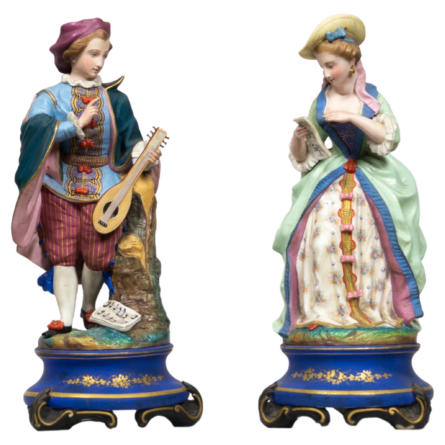 Figurines en porcelaine française du 19e siècle Joueur de guitare et Singer en vente