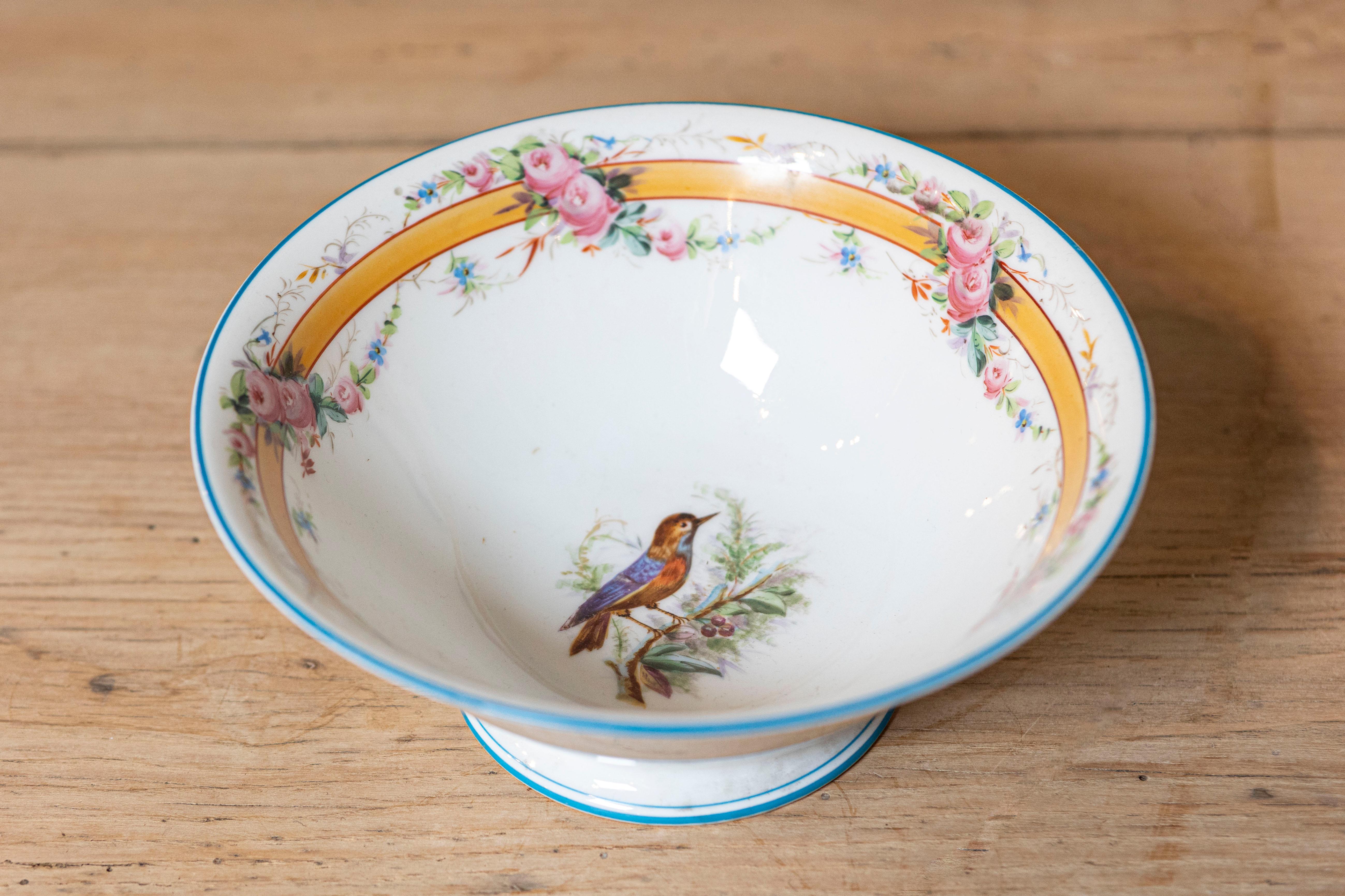 This 19th-century French porcelain piece is a finely crafted example of the decorative artistry of the time, likely influenced by the Rococo Revival or Neoclassical styles that were popular in French porcelain during this period. 

The bowl is