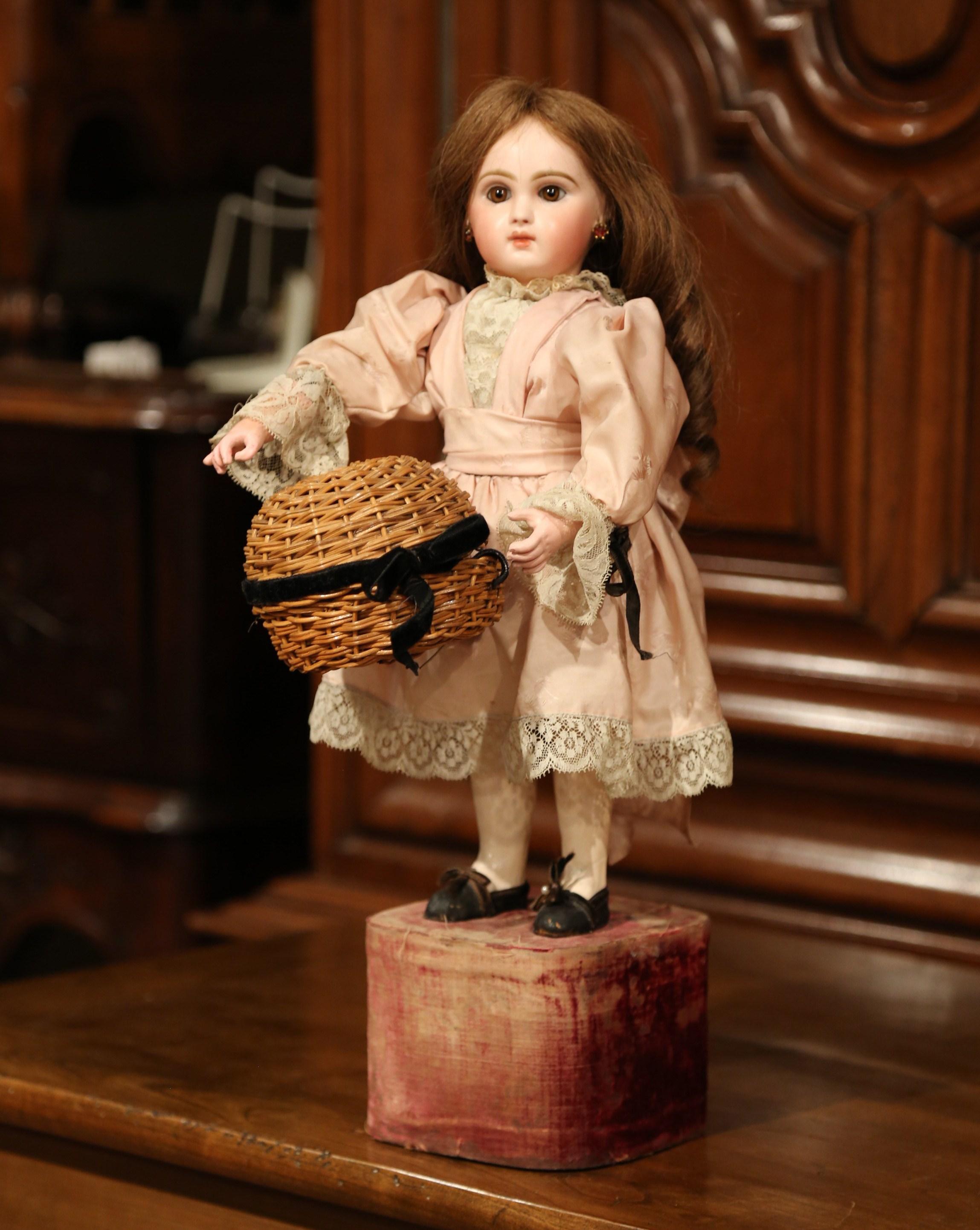 This is a true treasure for seasoned doll collectors! This 19th century doll by Jumeau was crafted in France circa 1870. The doll's head and right arm are in motion when the music is played by cranking the knob on the base. The head and hands are