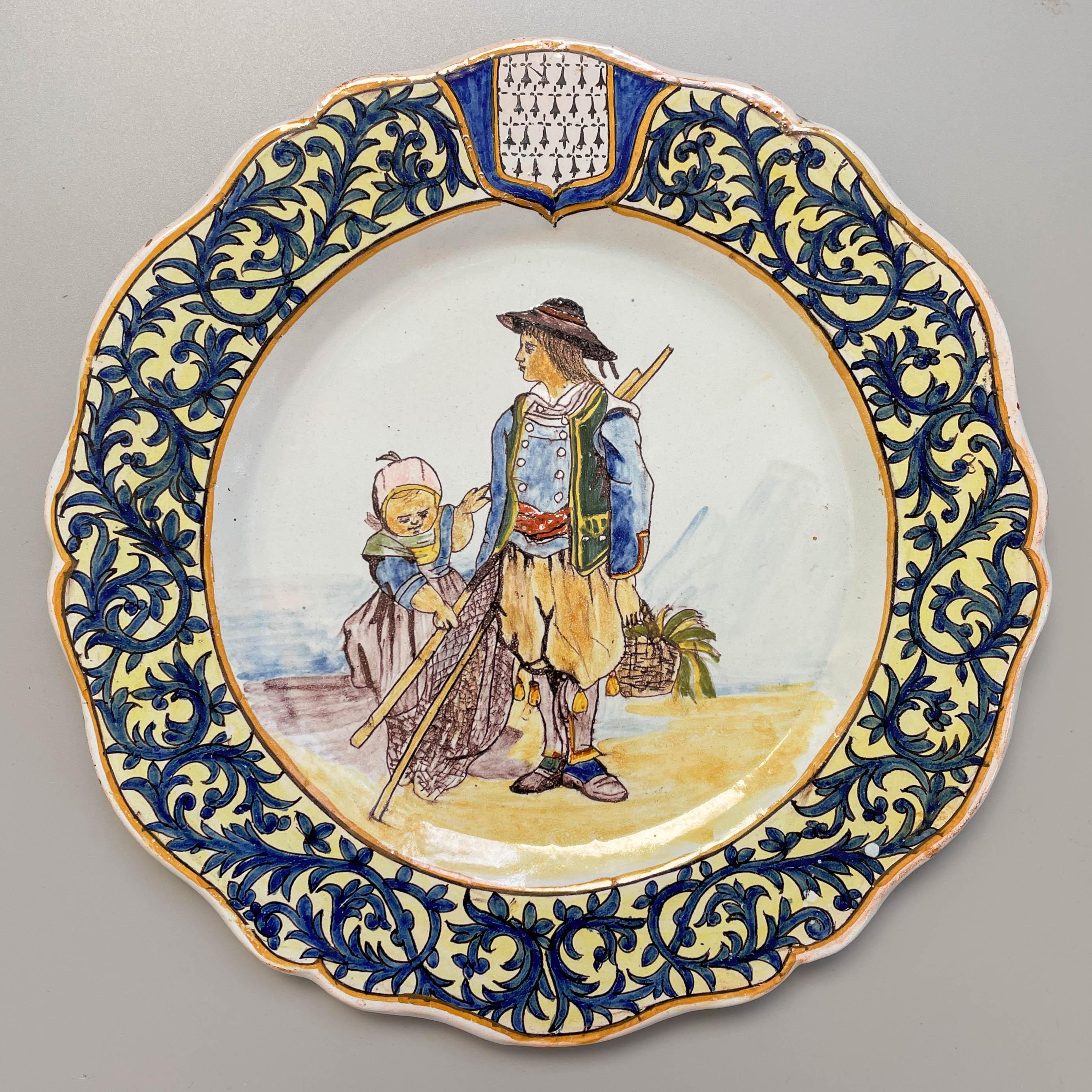 A 19th century French Porquier Beau Quimper faience plate with a fisherman and child scene. Foliate border with Brittany coat of arms. Good details. Small chips to glaze on back rim. Mark verso: PB. Minor wear. Circa 1895-1900.
Dimensions:  9.25