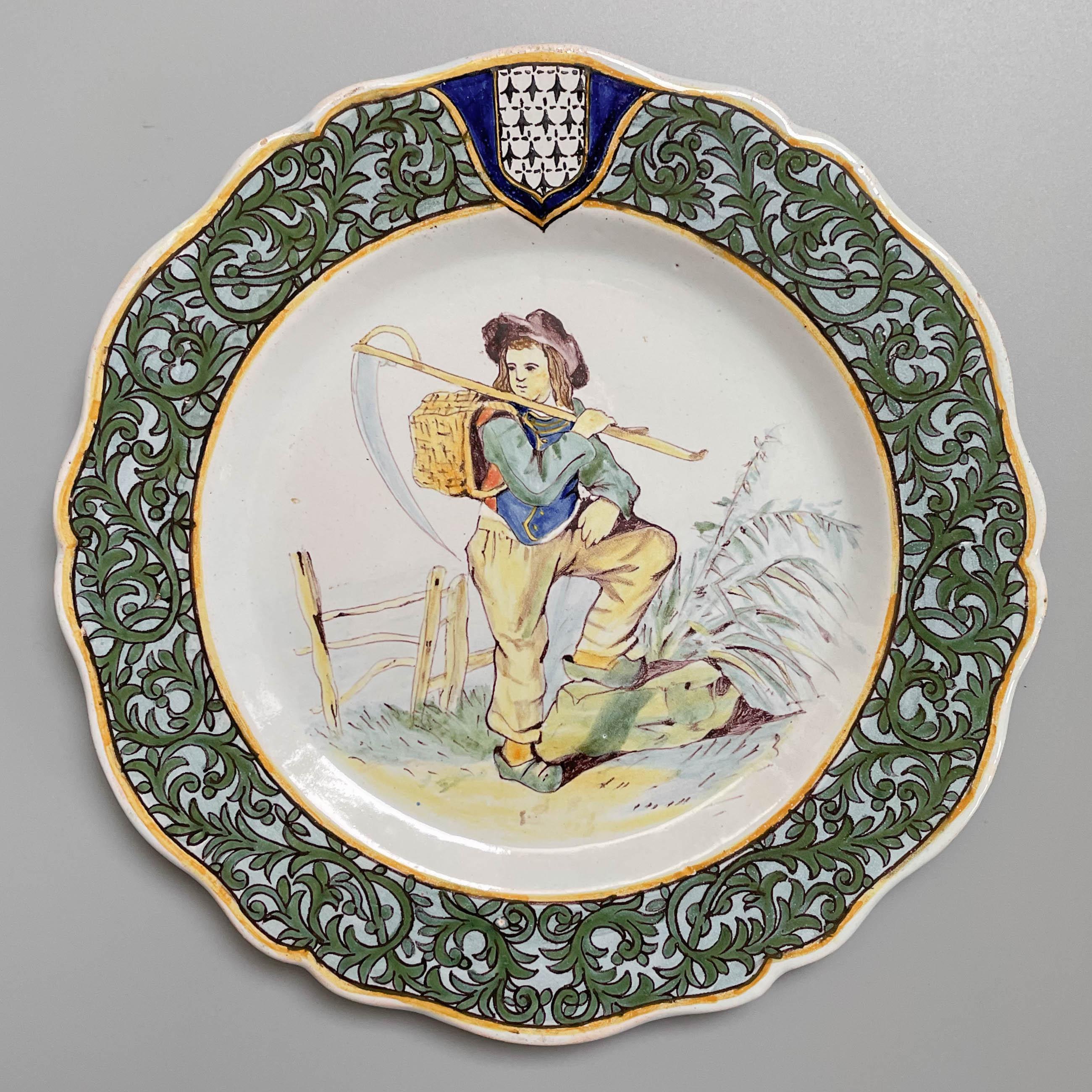 A 19th century French Porquier Beau Quimper faience plate with a young farmer holding a scythe. Foliate border with Brittany coat of arms. Good details. Minor chips to glaze on back. Mark verso: PB Fouesnant. Circa 1895-1900.
Dimensions:  9.25