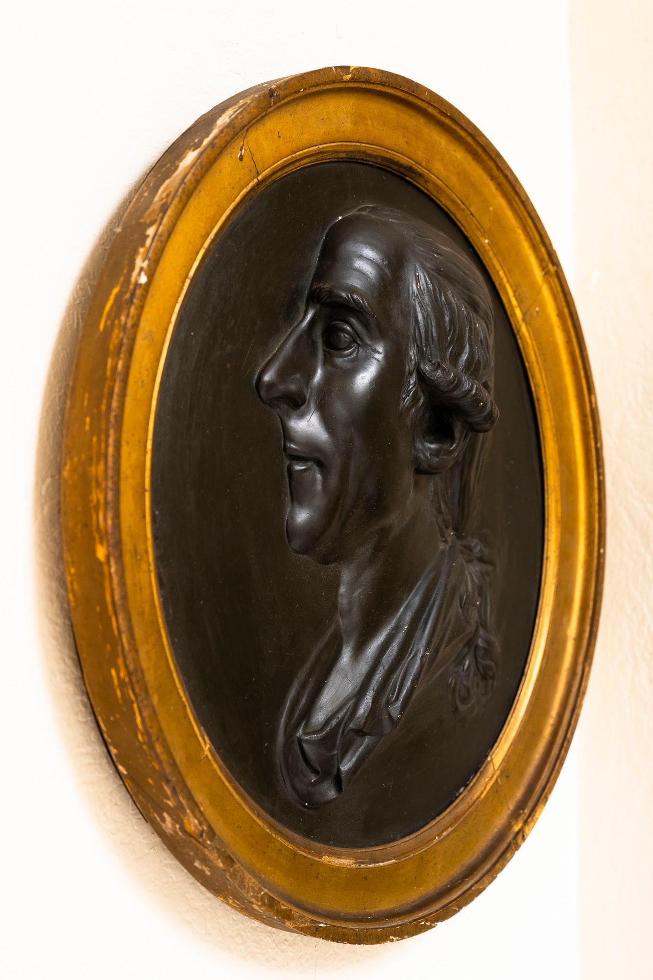 This portrait bust in relief of a French nobleman is mounted in the original gilt frame, though the subject’s identity and the artist remain a mystery. Beautifully sculpted, the bust remains in good condition, however the giltwood frame has suffered