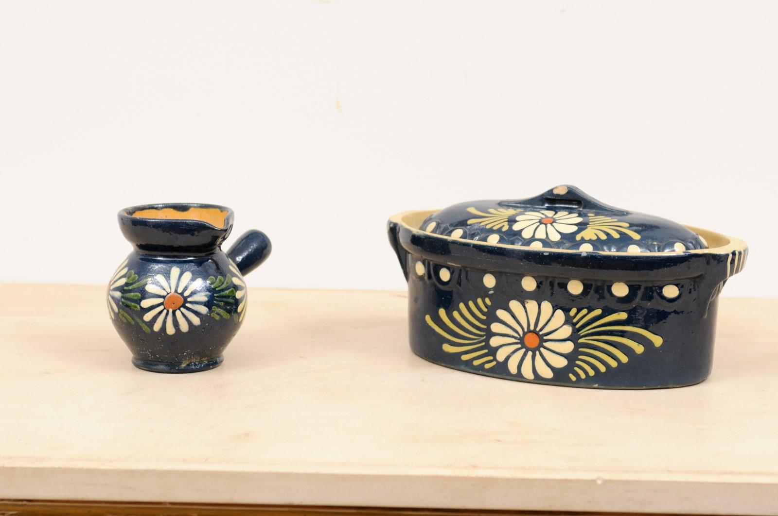 Two French pottery serving pieces from the 19th century, with blue glaze and white flowers. They are priced and sold separately, $525 for the casserole dish and $325 for the pot. Created in France during the 19th century, this pottery set features