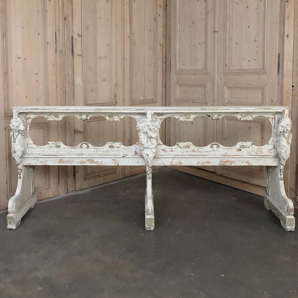 19th Century Italian Painted Bench with Angels features incredible hand-carved sculptures of angels on each end and at the middle, originally designed as a church pew for an opulent private chapel.  Distressed painted finish adds a pleasing
