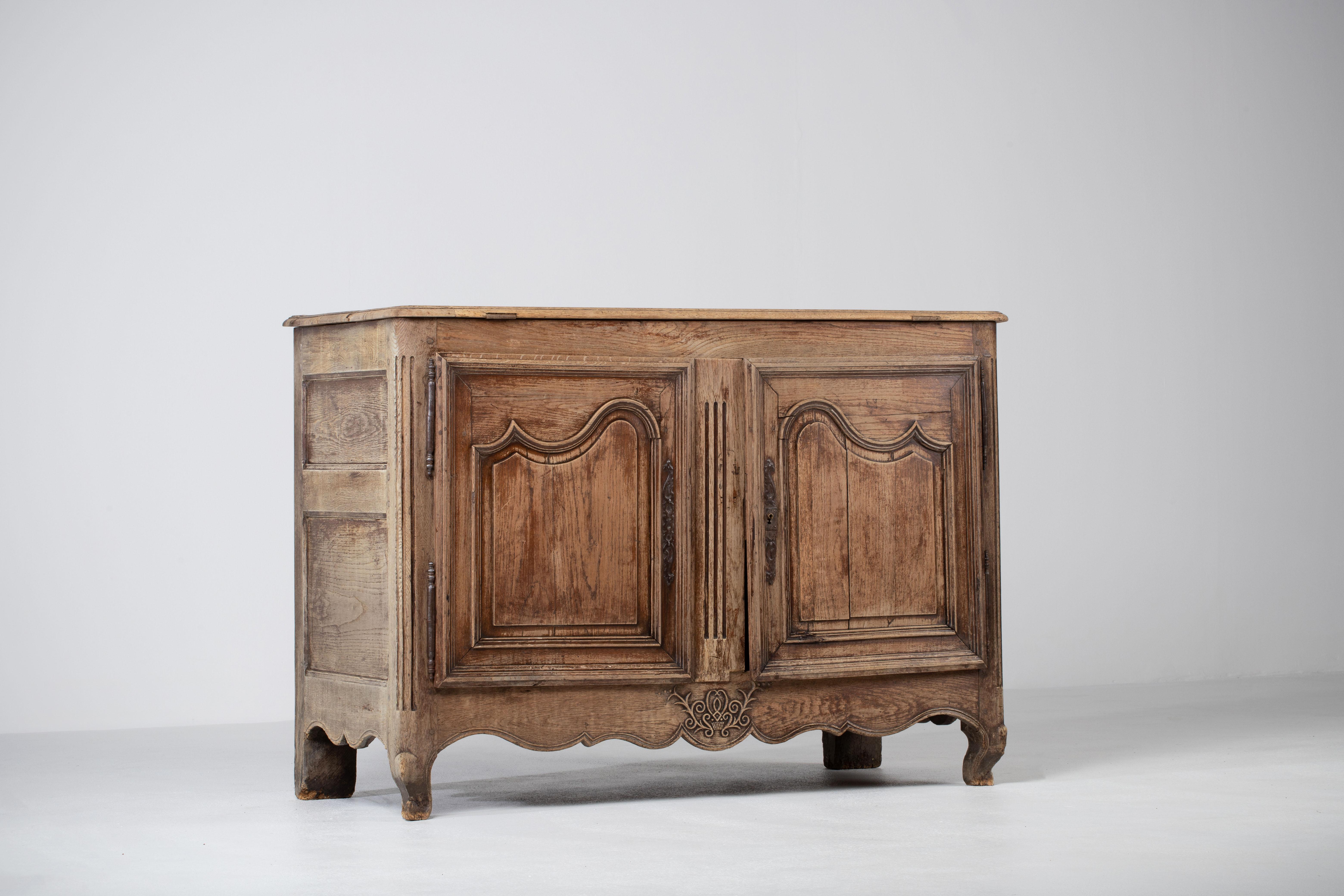 A two door and drawer provencal cabinet from France, circa 1890. Representing the casual yet refined aesthetic of the French countryside, patinated, enhancing the natural textured figure of the wood and subtle carved ornament. 
A testament to the