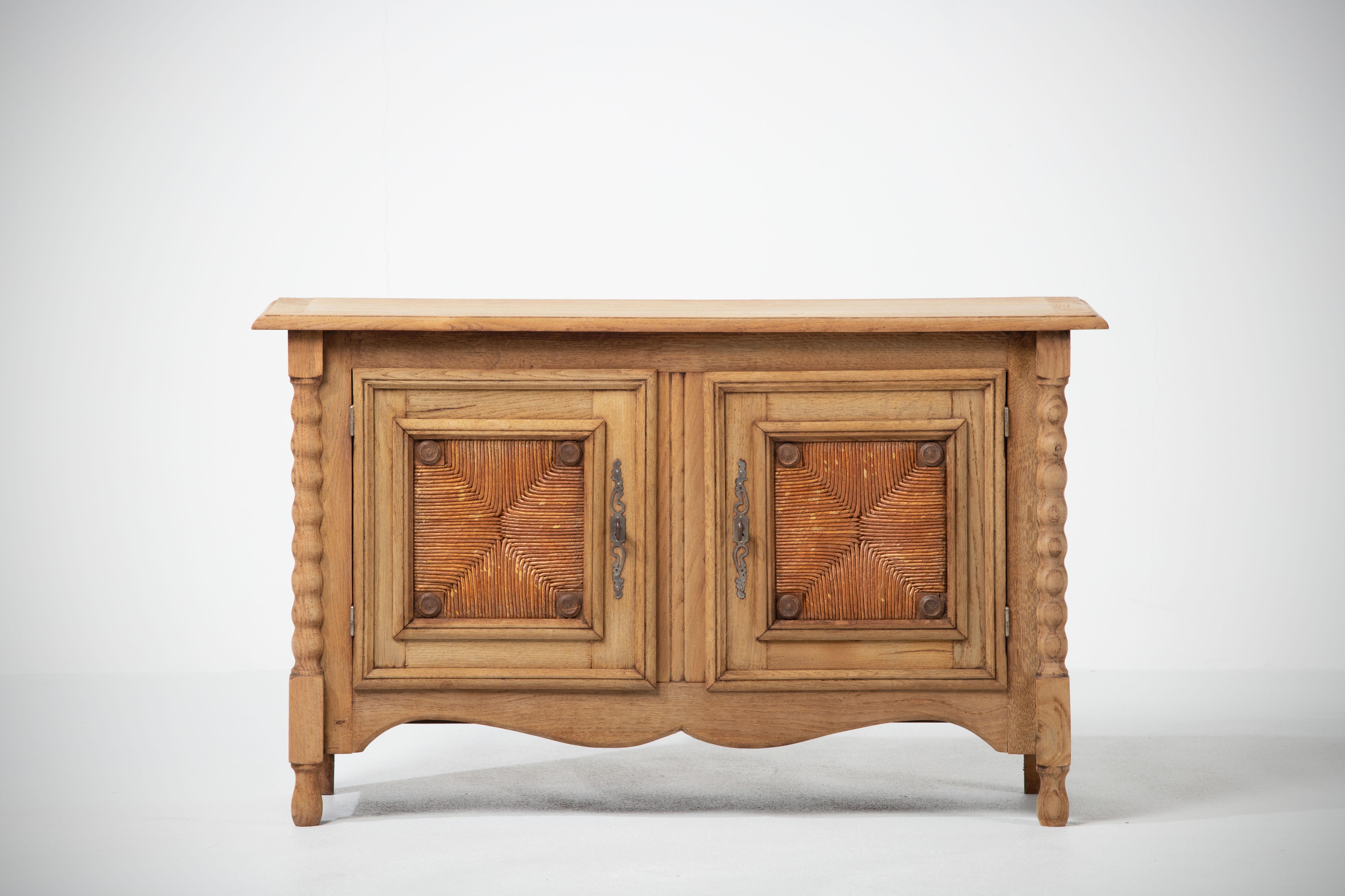 A two door provencal cabinet from France, circa 1940. 
Representing the casual yet refined aesthetic of the French countryside, patinated, enhancing the natural textured figure of the wood and subtle carved ornament. 
A testament to the durability