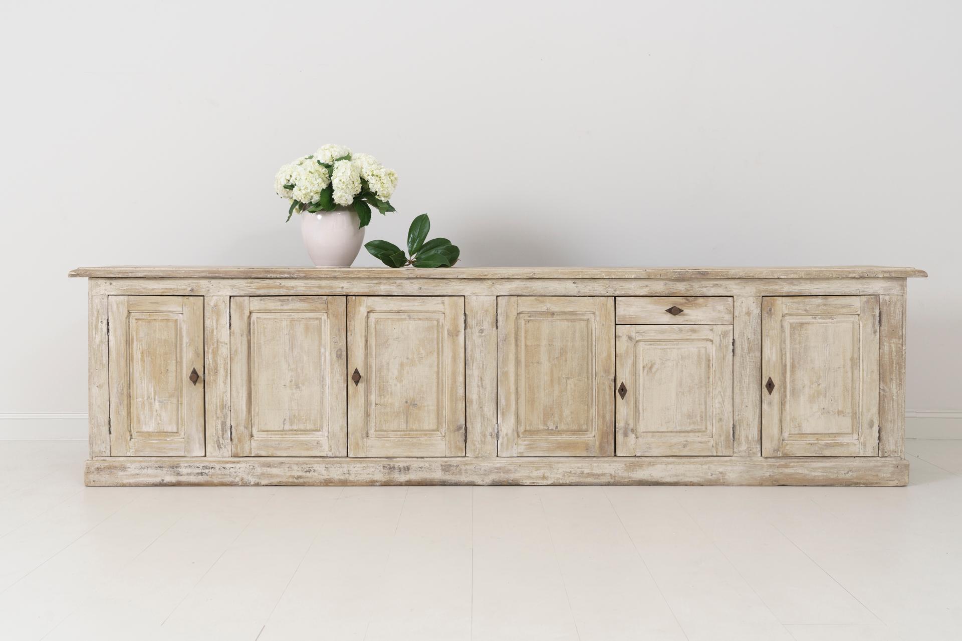 A 19th century French Louis Philippe enfilade found in Provence. This beautiful six-door and one drawer sideboard or buffet has been hand dry-scraped down to the original gesso, circa 1880. The shelves are 17 inches deep. This is a great piece with