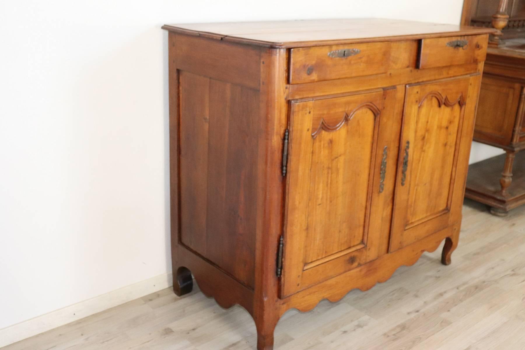 Beautiful French Provencal cherry wood sideboard. The doors have a motif blurred. Even the wavy and slender feet recall the Louis XV style.
Ideal sideboard in any environment, beautiful warm and clear color of cherrywood. Very spacious inside.