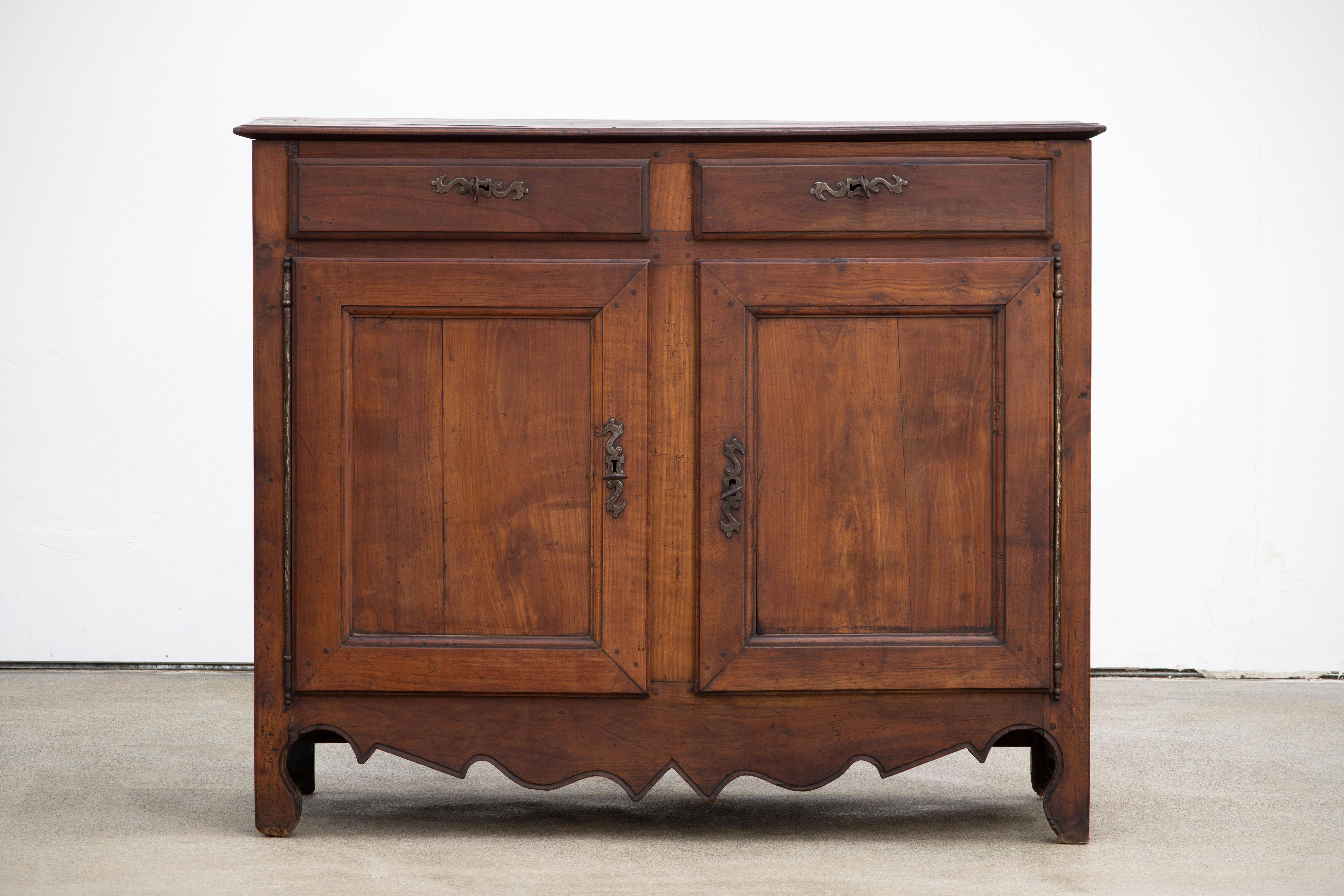 A two door and drawer provencal cabinet from France, circa 1890. Representing the casual yet refined aesthetic of the French countryside, finished in a contemporary bright finish, enhancing the natural textured figure of the wood and subtle carved