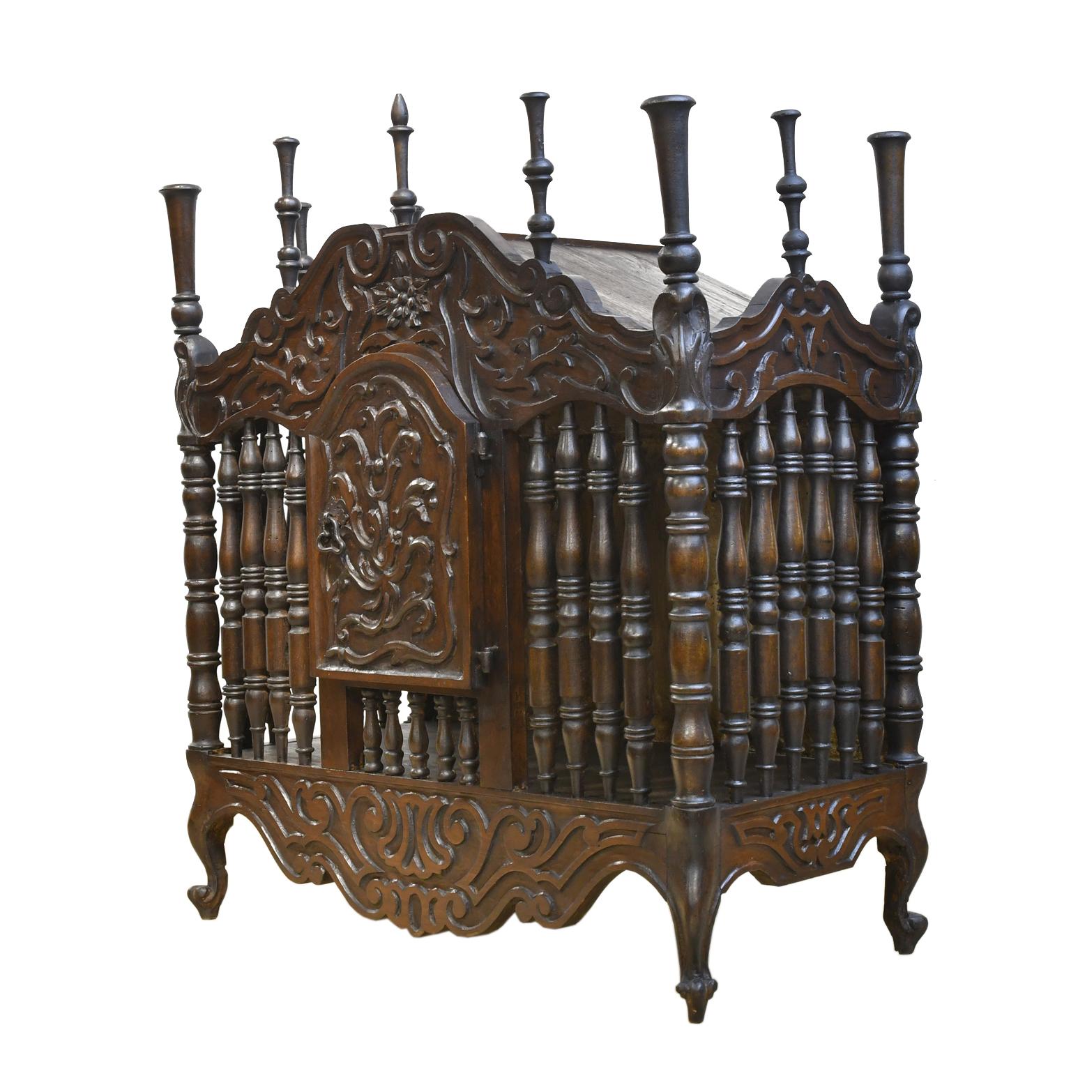 A very charming and rustic French Provincial bread cupboard or panetière in French chestnut. France, circa 1800s. This highly decorated box intended for storing bread has an arched bonnet, cabinet door and aprons embellished with floral, foliate and